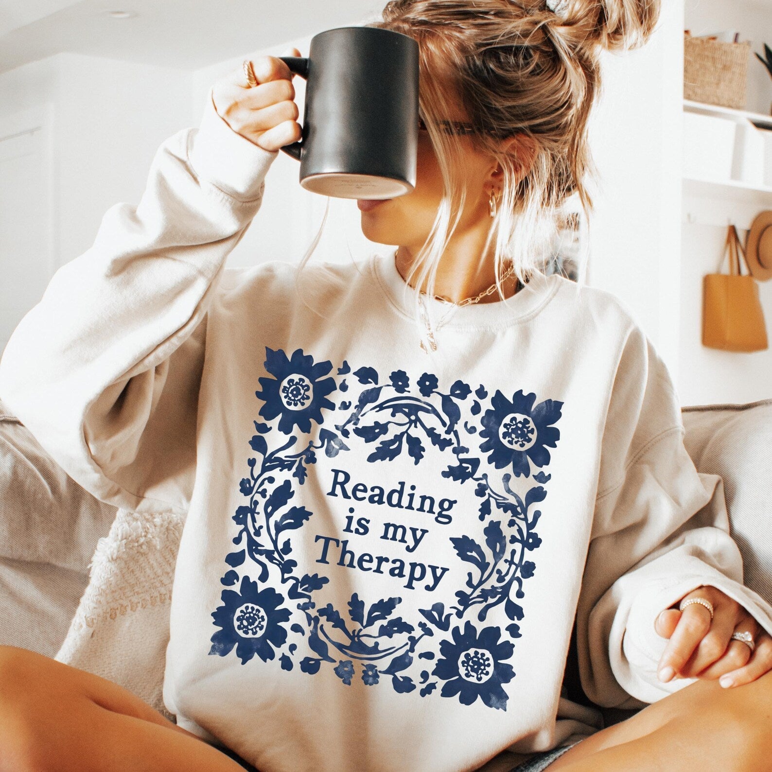 Black graphic tee from Anchored Grace Boutique featuring the phrase "Reading is My Therapy" in stylish white lettering.