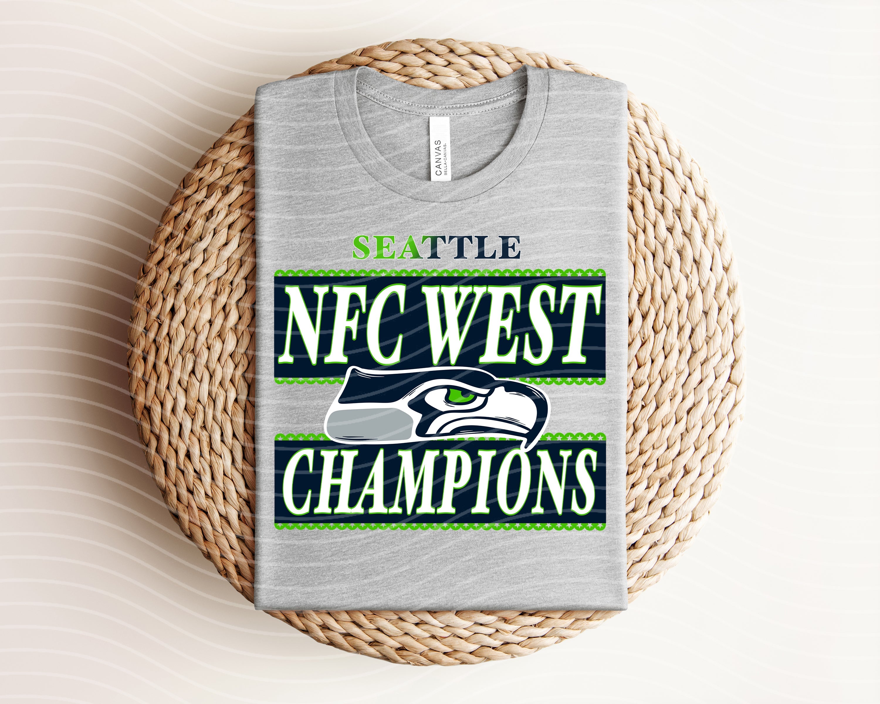 Seahawks NFC West Champions graphic tee in navy with team logo and celebratory design, worn by a person, from Anchored Grace Boutique