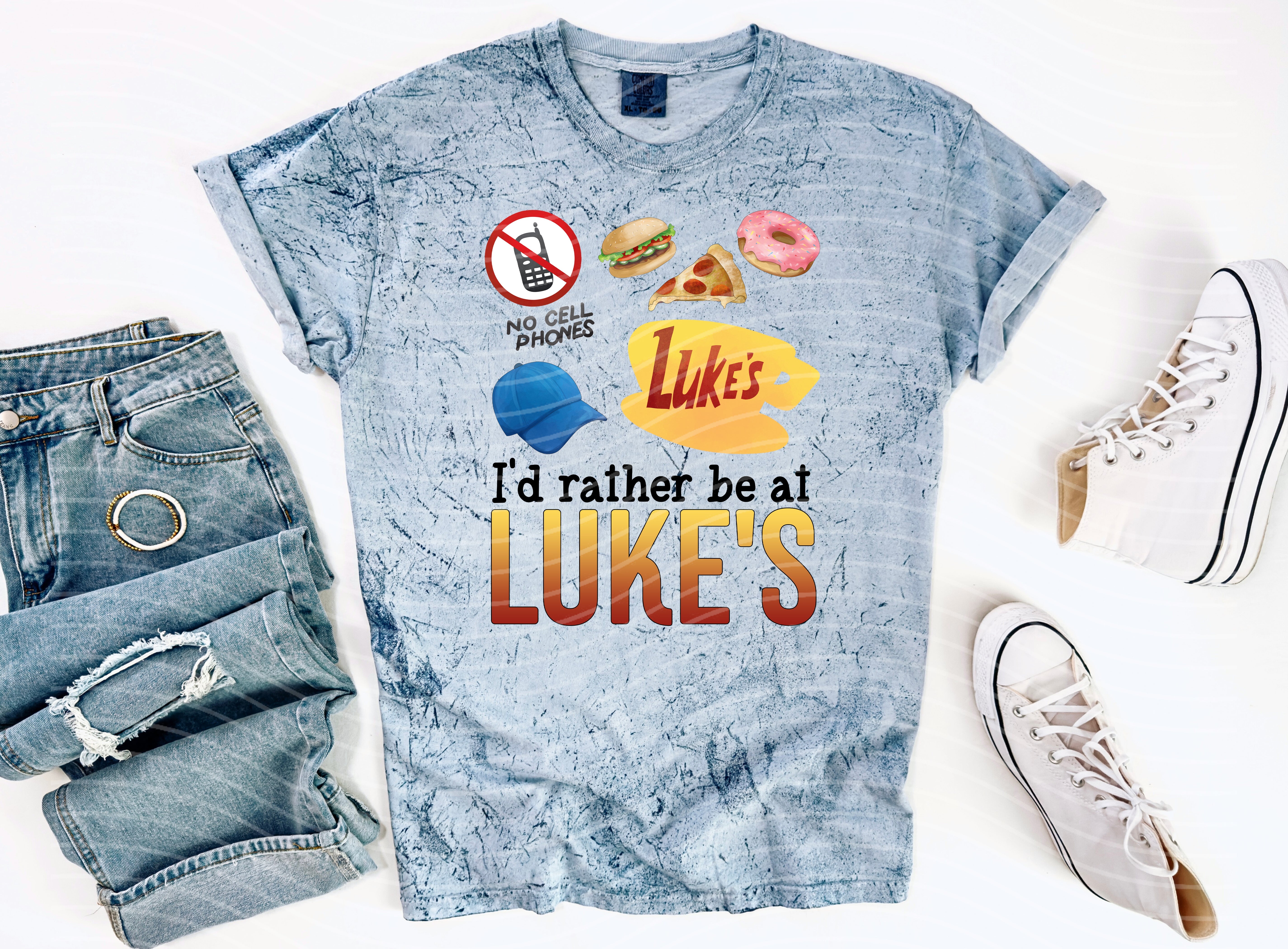 Black graphic tee by Anchored Grace Boutique featuring "I'd Rather Be at Luke's" slogan, casual and stylish for everyday wear.