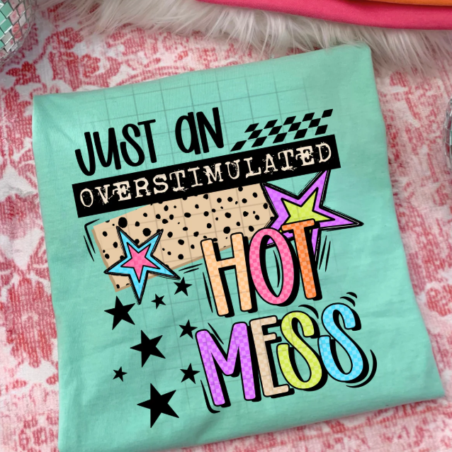 Black graphic tee with "Just an Overstimulated Hot Mess" text from Anchored Grace Boutique, casual style, front view.