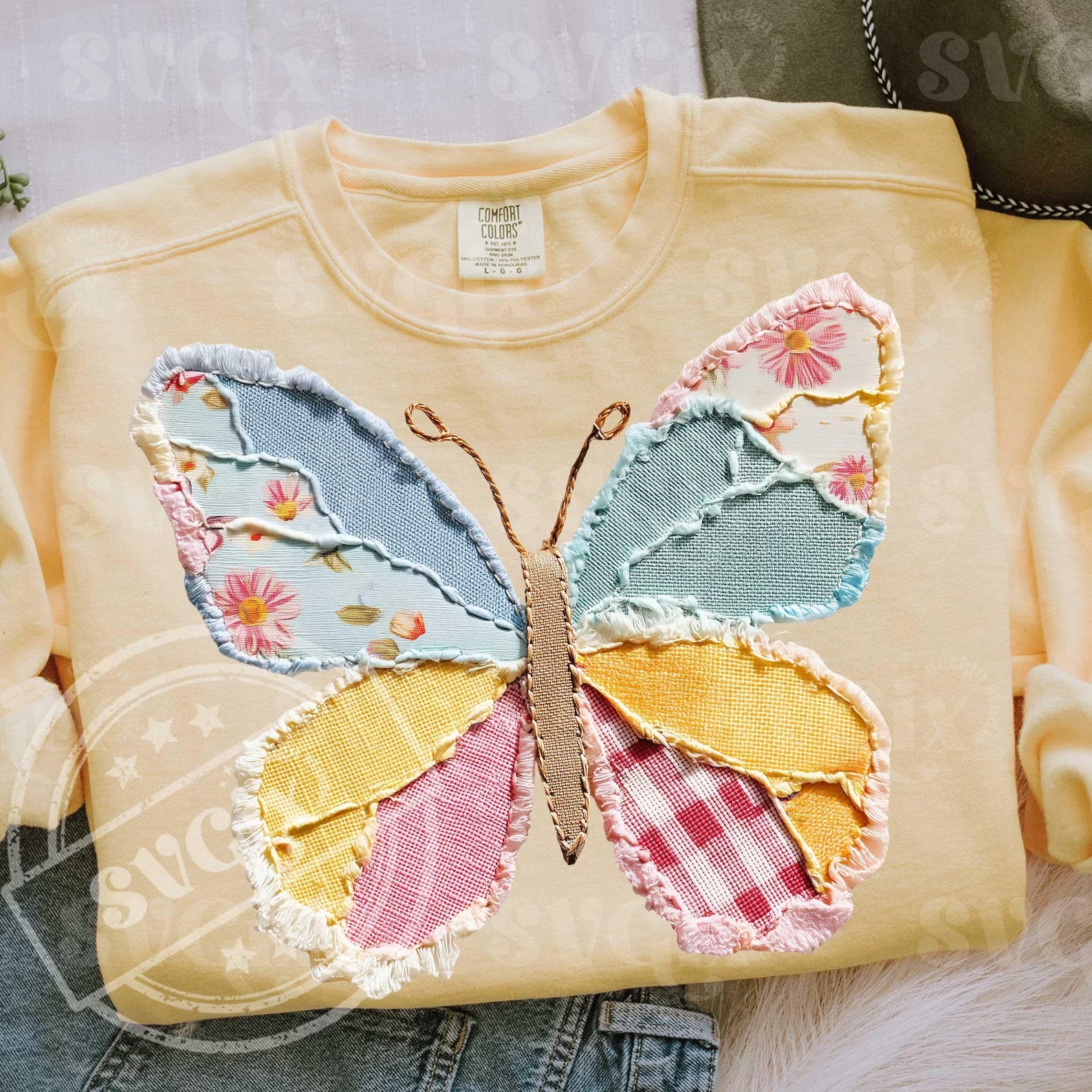 Patchwork butterfly graphic tee from Anchored Grace Boutique featuring colorful patchwork design and butterfly illustration.