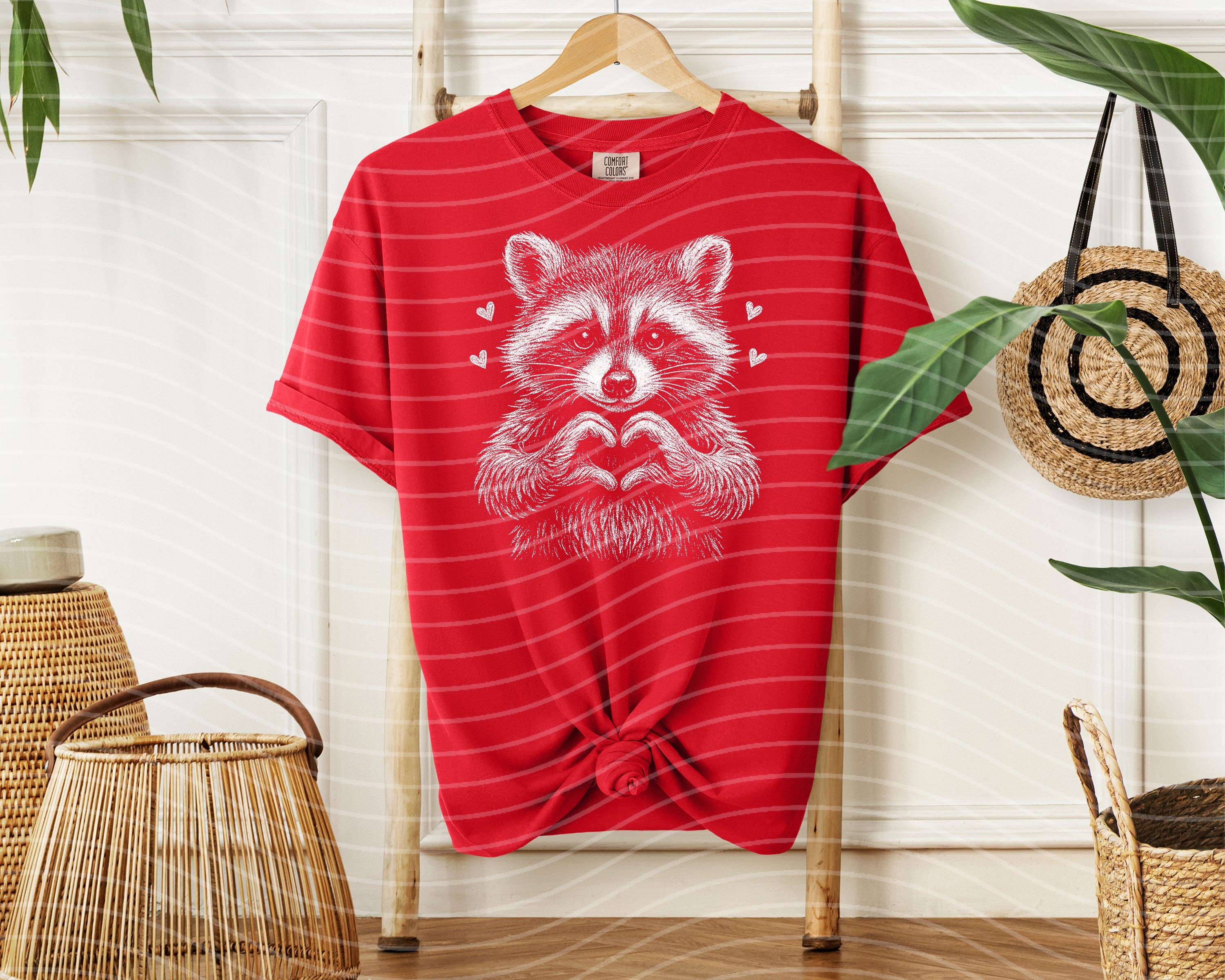 Black and white raccoon graphic tee from Anchored Grace Boutique, casual cotton t-shirt with playful animal illustration.