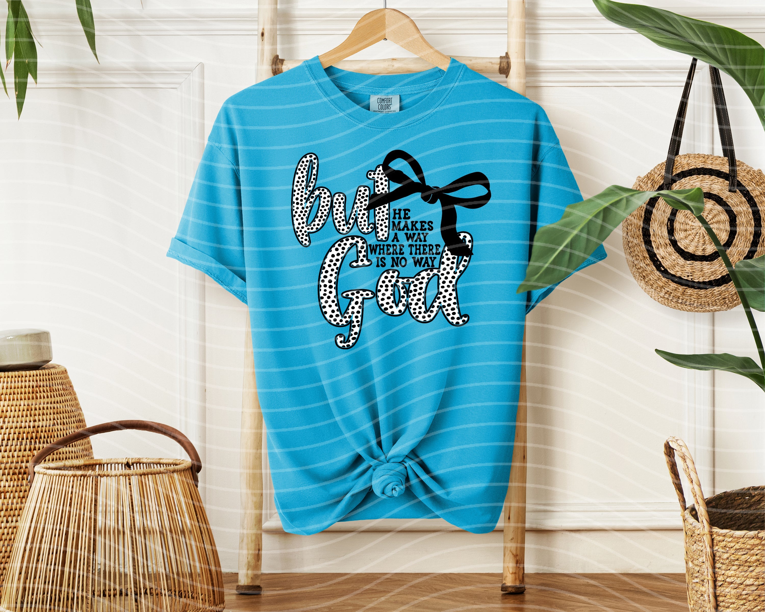 Black But God graphic tee by Anchored Grace Boutique featuring bold white text on soft cotton fabric.