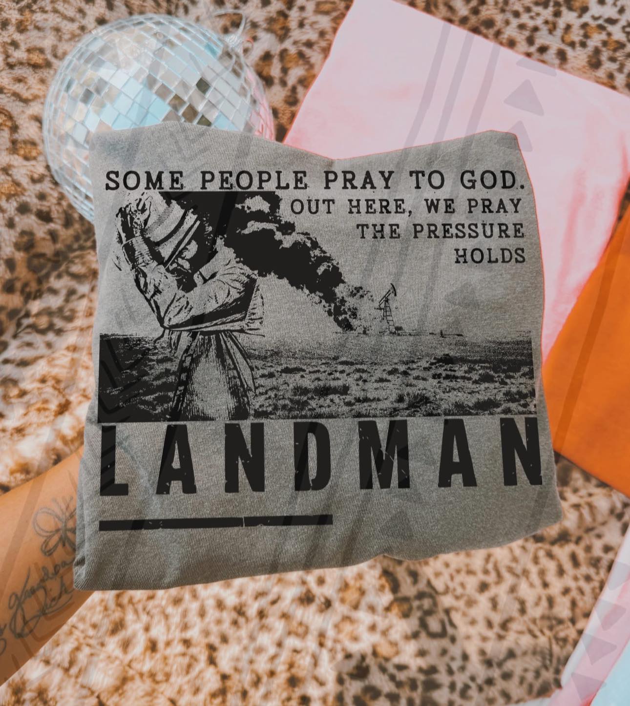 Black graphic tee featuring a prayer-themed design from Anchored Grace Boutique, with the phrase "Some People Pray to God" in bold lettering.