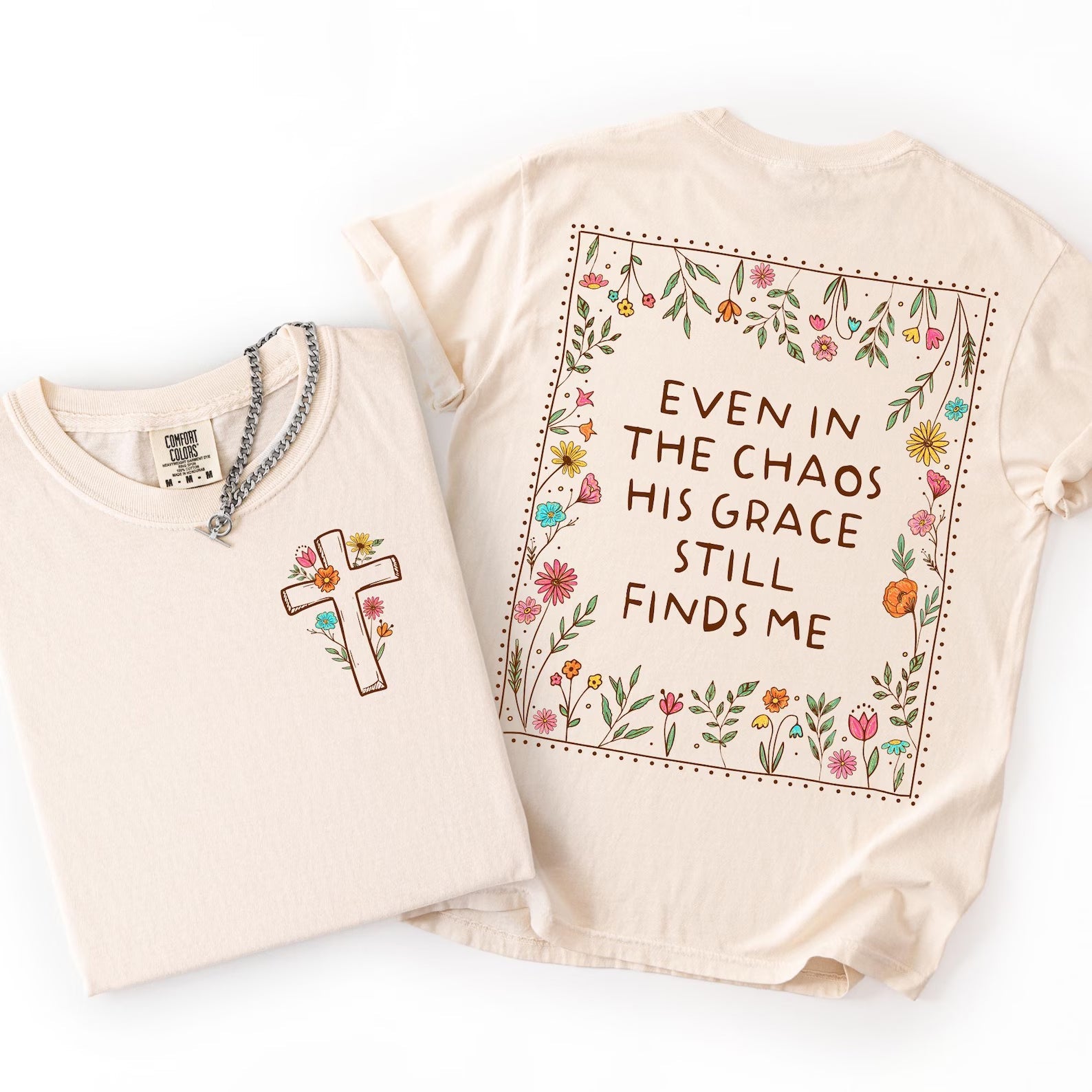 Graphic tee by Anchored Grace Boutique featuring a design with the phrase "Even in the Chaos His Grace Still Finds Me" printed on the front.