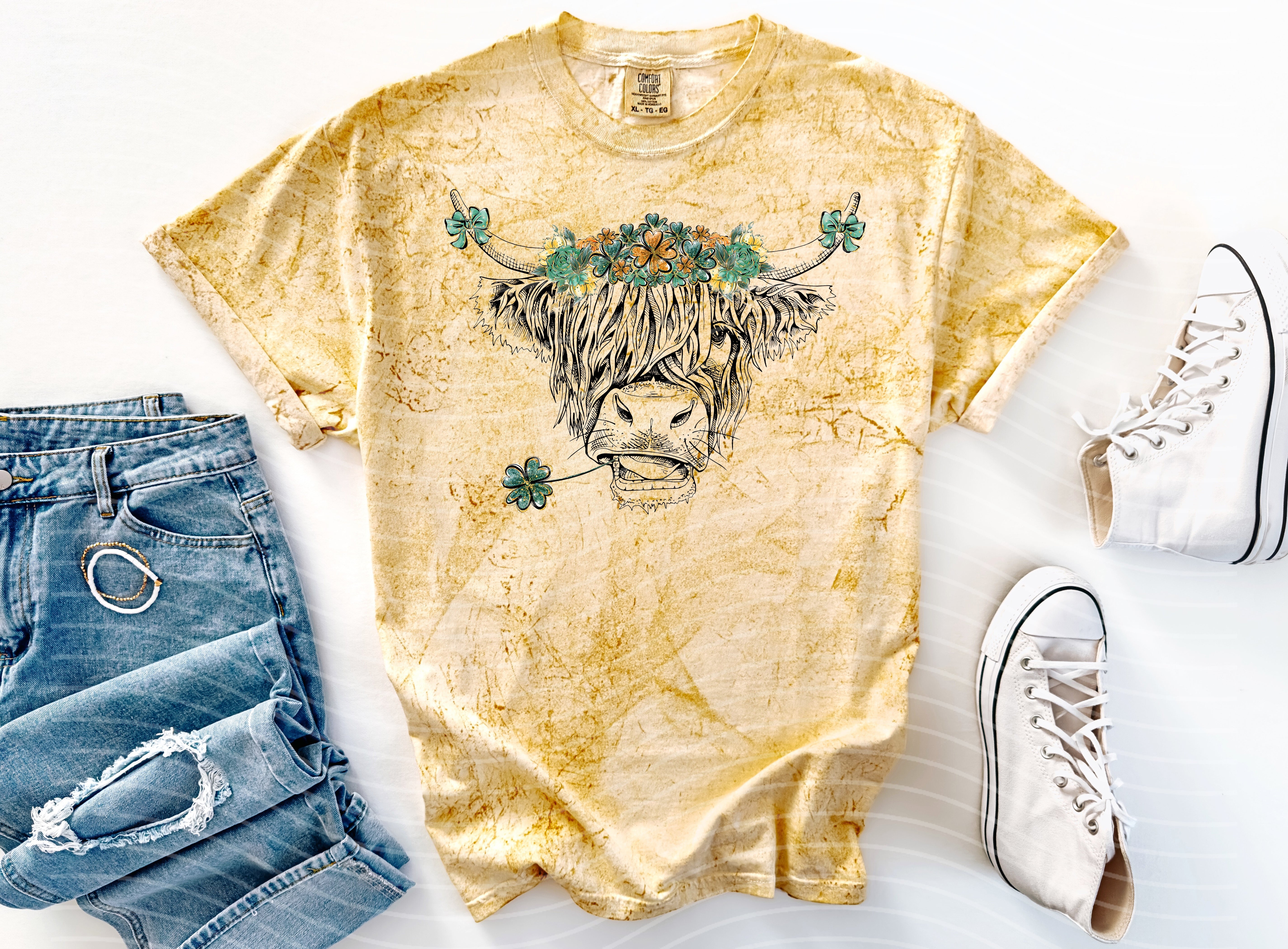 Green St. Patrick's Day cow graphic tee from Anchored Grace Boutique, featuring a playful cow design on soft cotton fabric.