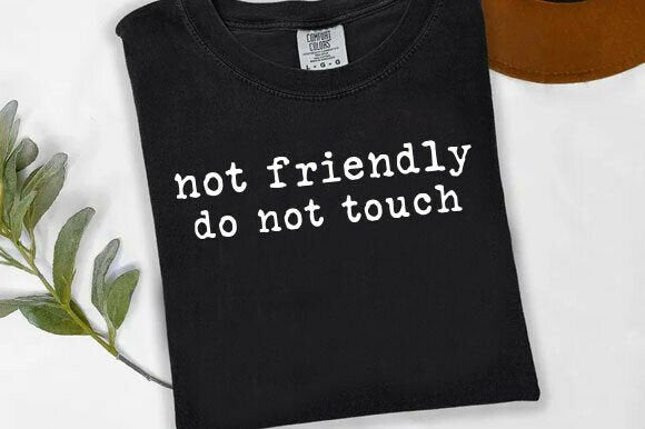 Black graphic tee from Anchored Grace Boutique with "Not Friendly Do Not Touch" slogan and bold white lettering.