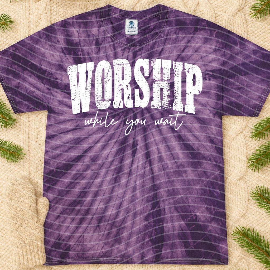 Black graphic tee from Anchored Grace Boutique featuring inspirational "Worship While You Wait" text and modern design.