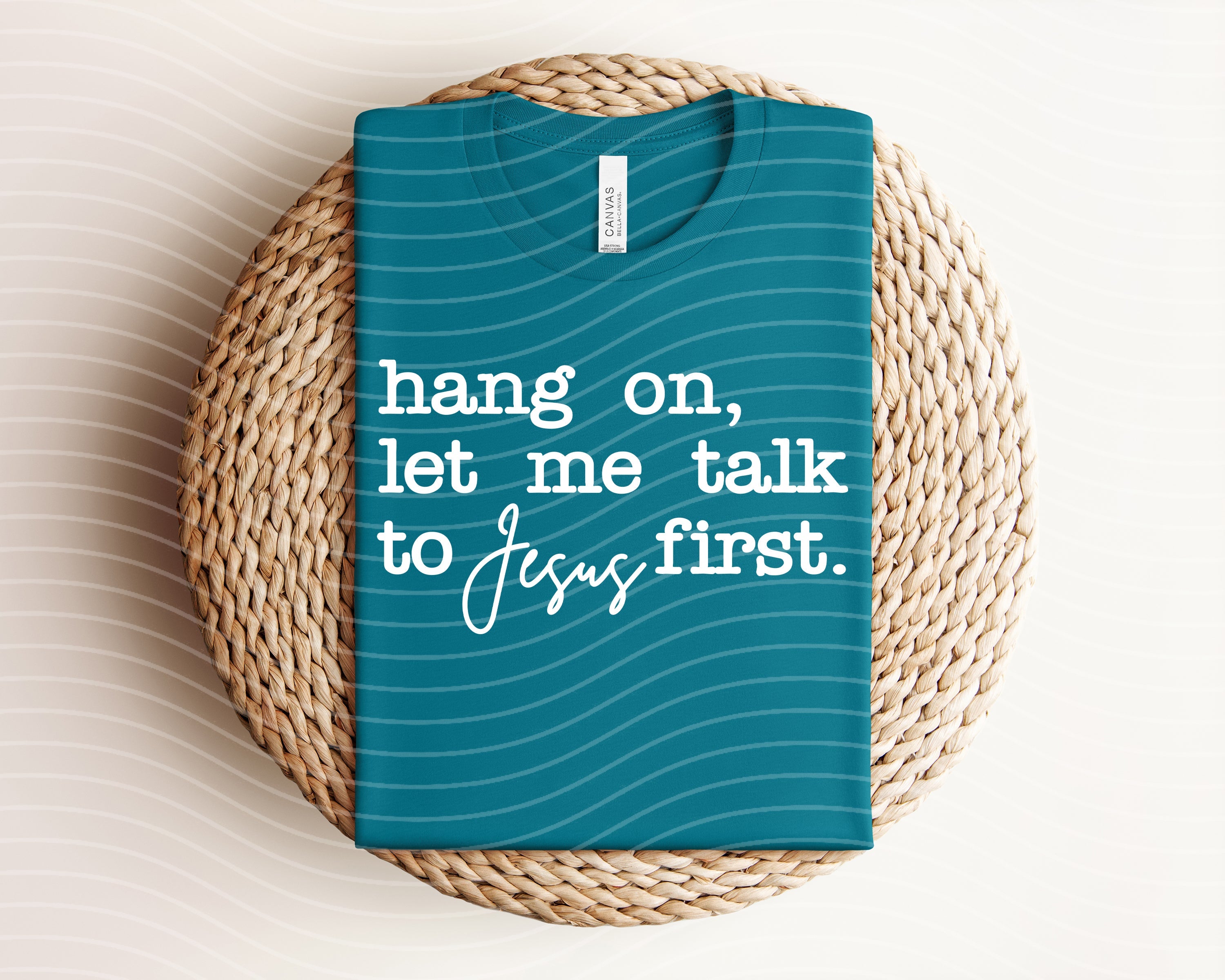 Graphic tee featuring "Hang on, Let Me Talk to Jesus First" slogan, casual fit, white fabric, from Anchored Grace Boutique.