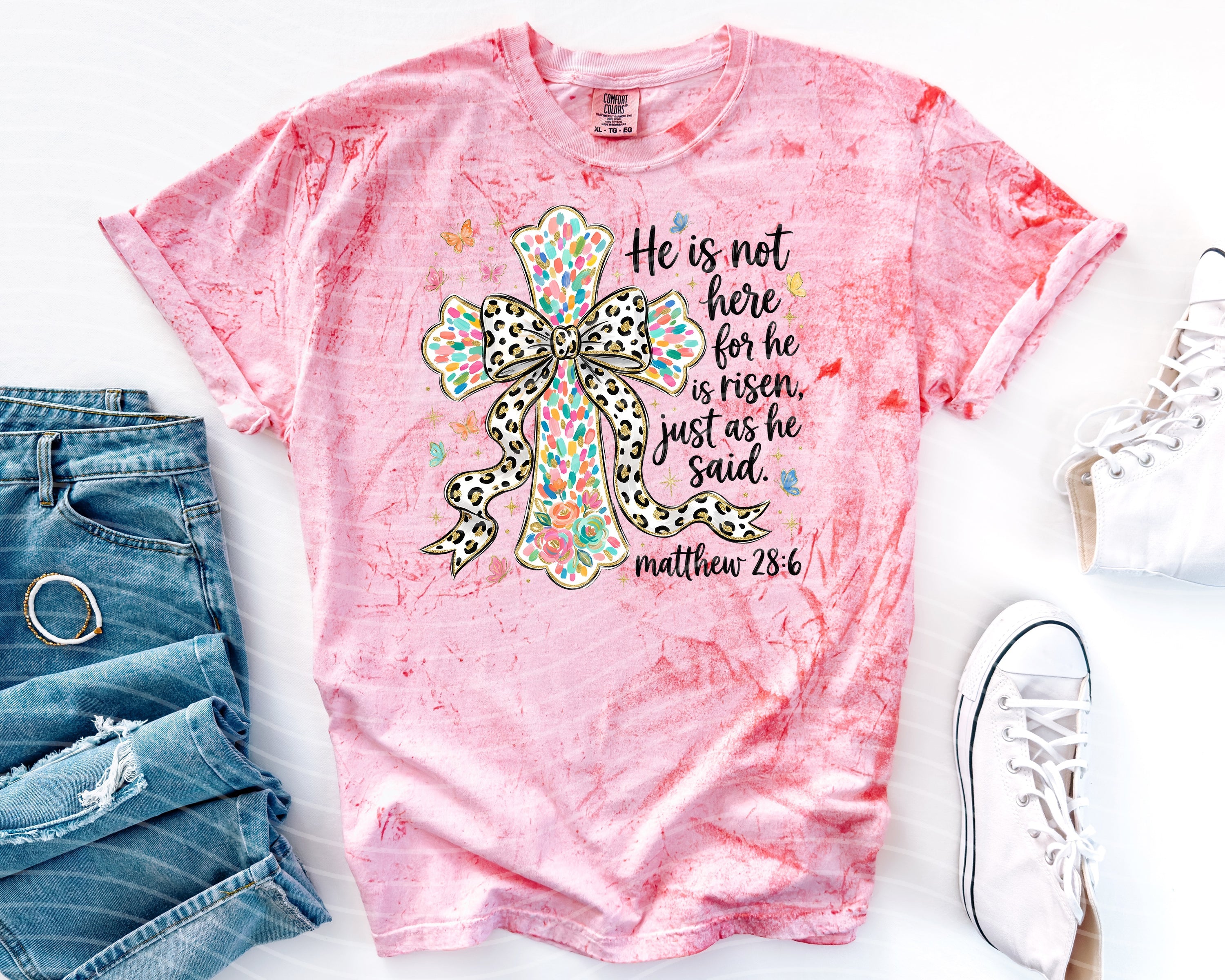 Black "He is Not Here" graphic tee by Anchored Grace Boutique, casual T-shirt with bold text design.