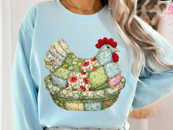 Patchwork Hen graphic tee from Anchored Grace Boutique featuring colorful patchwork design and a hen illustration on soft fabric.