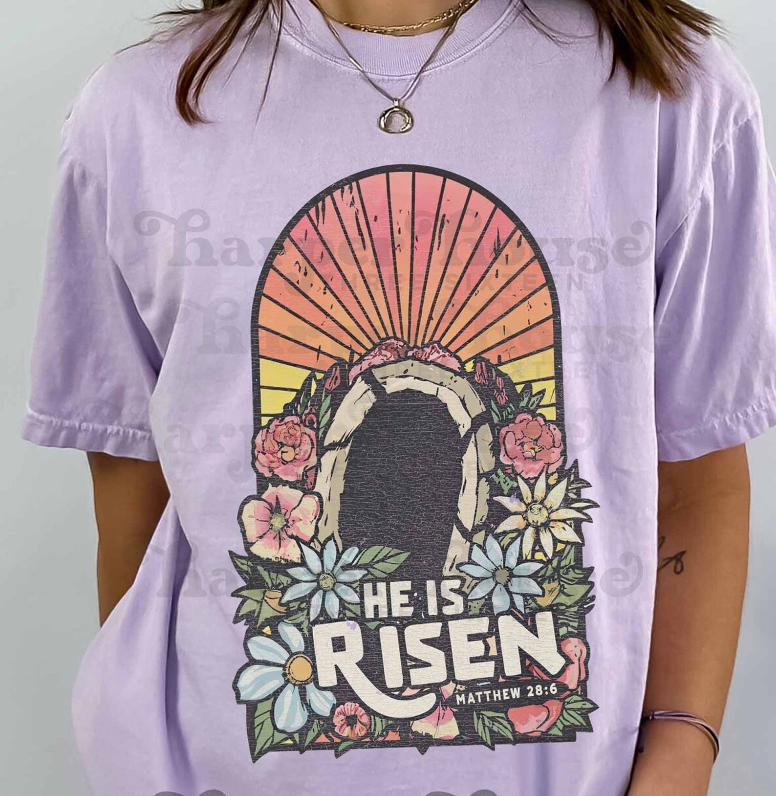 He is Risen graphic tee from Anchored Grace Boutique, featuring bold religious-themed design on a casual cotton t-shirt.