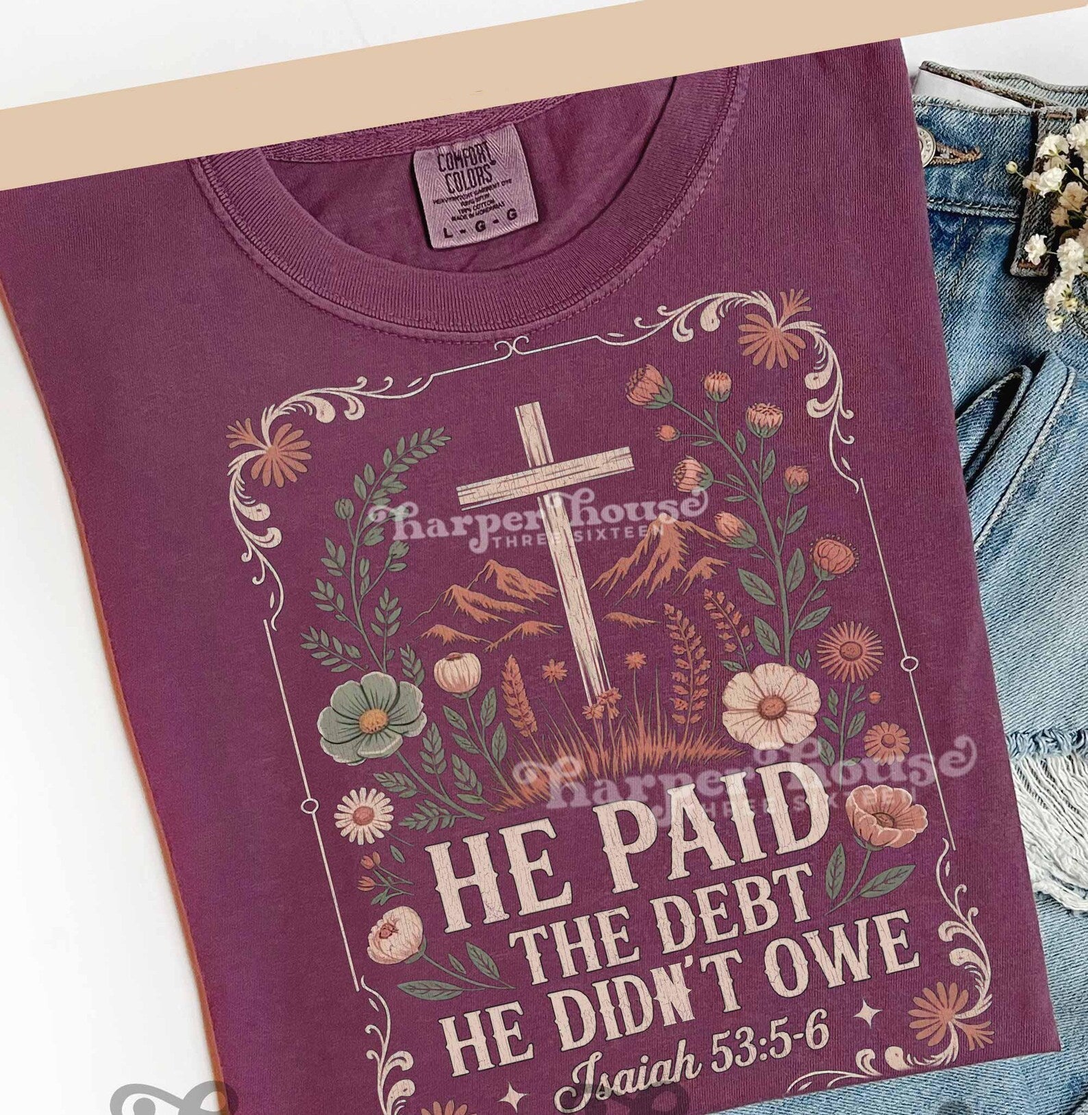 Men's graphic tee by Anchored Grace Boutique featuring the quote "He Paid the Debt He Didn't Owe" in bold black text.