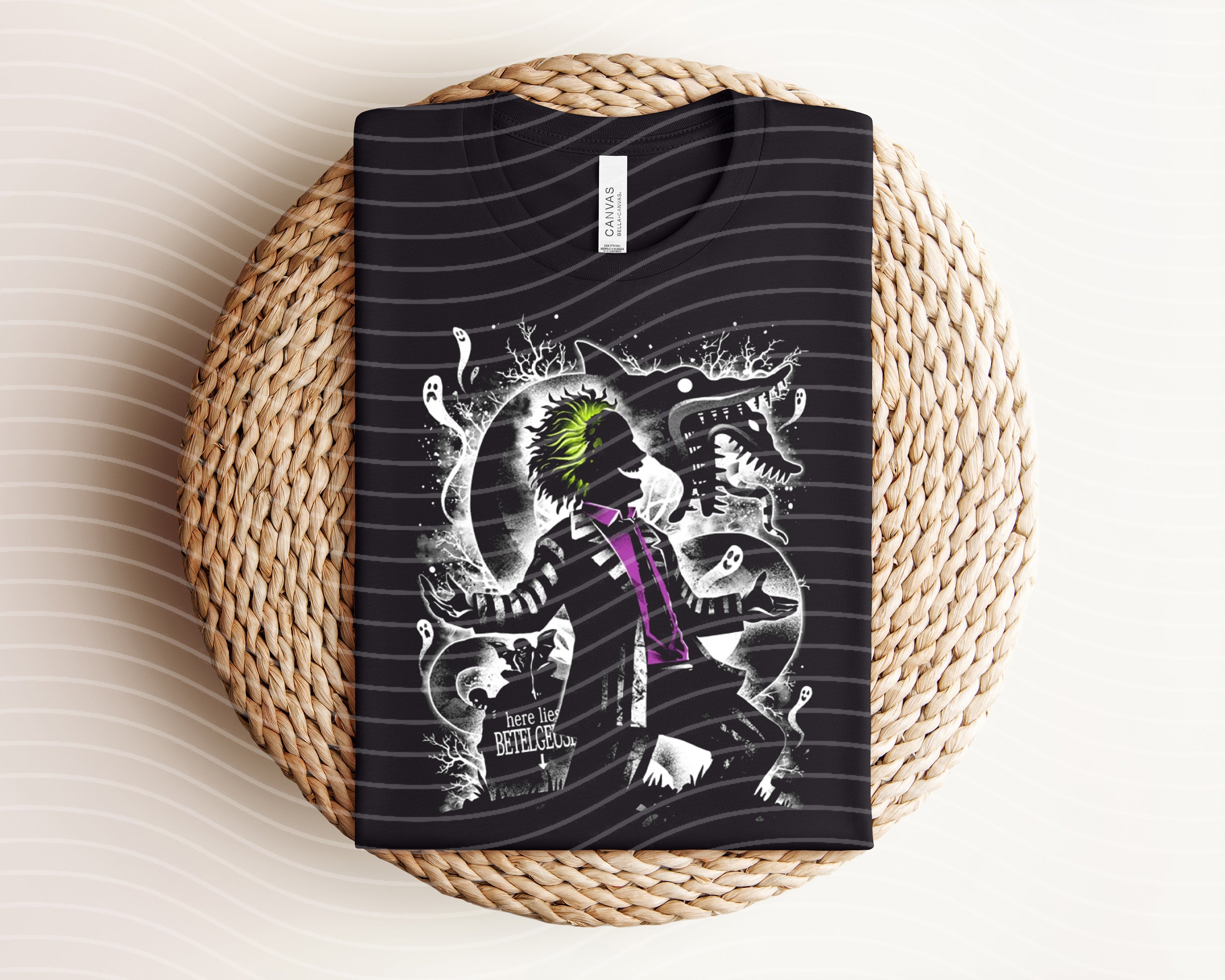 Dark graphic tee featuring Beetlejuice design from Anchored Grace Boutique, with bold graphic artwork on black fabric.
