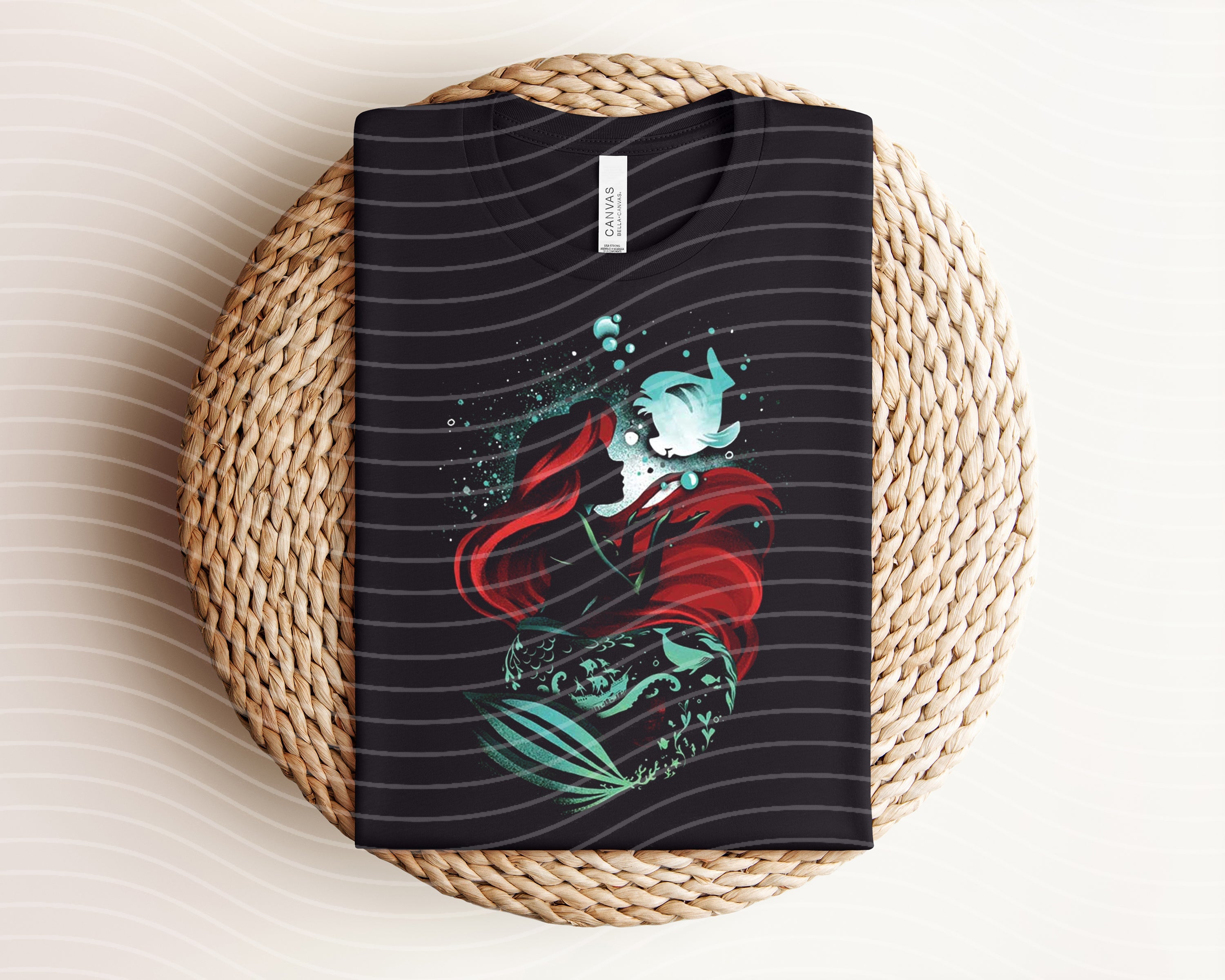 Ariel dark graphic tee by Anchored Grace Boutique featuring a stylish black T-shirt with bold graphic design.