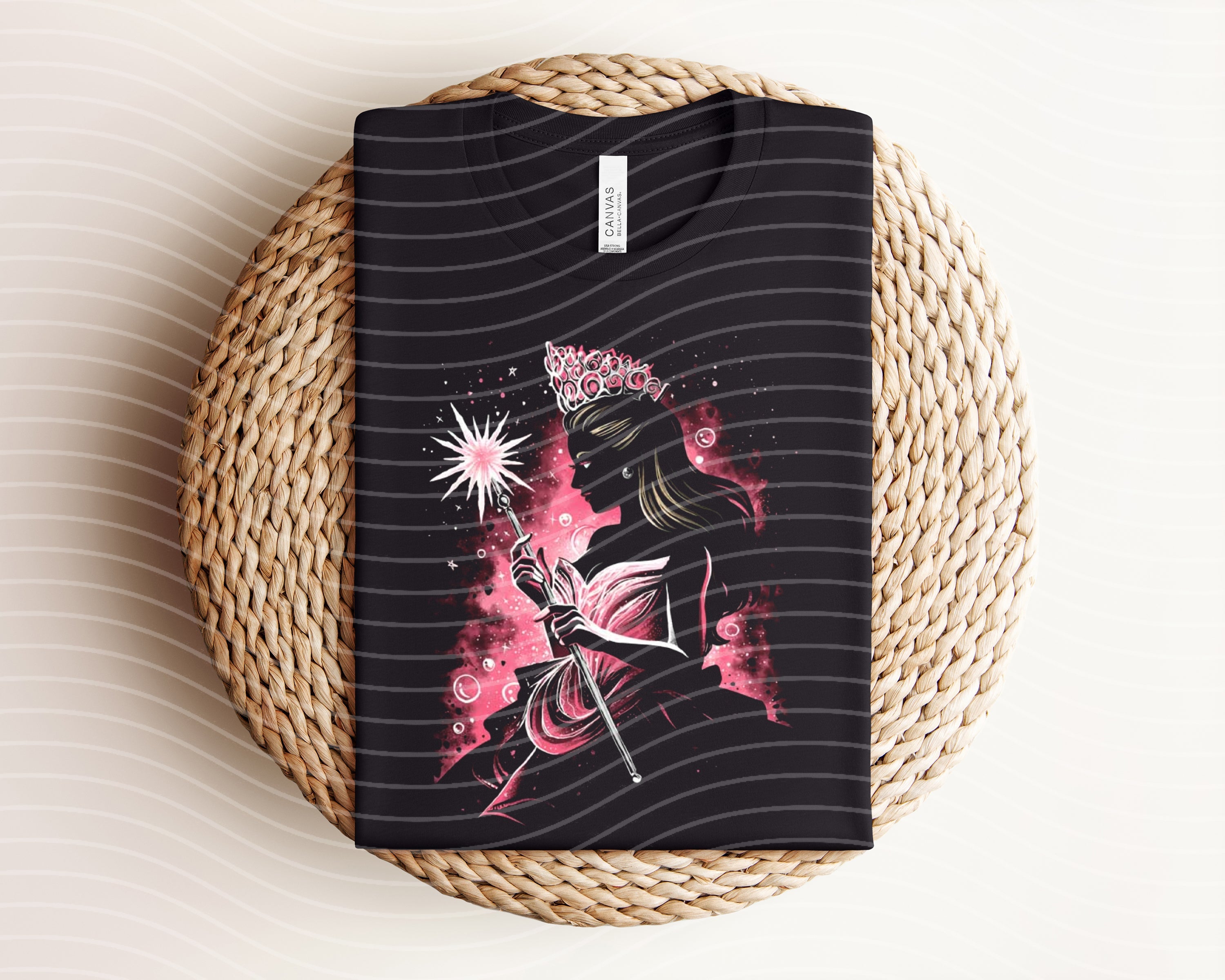 Dark graphic tee featuring a witch design from Anchored Grace Boutique, with a black fabric background and detailed witch illustration.