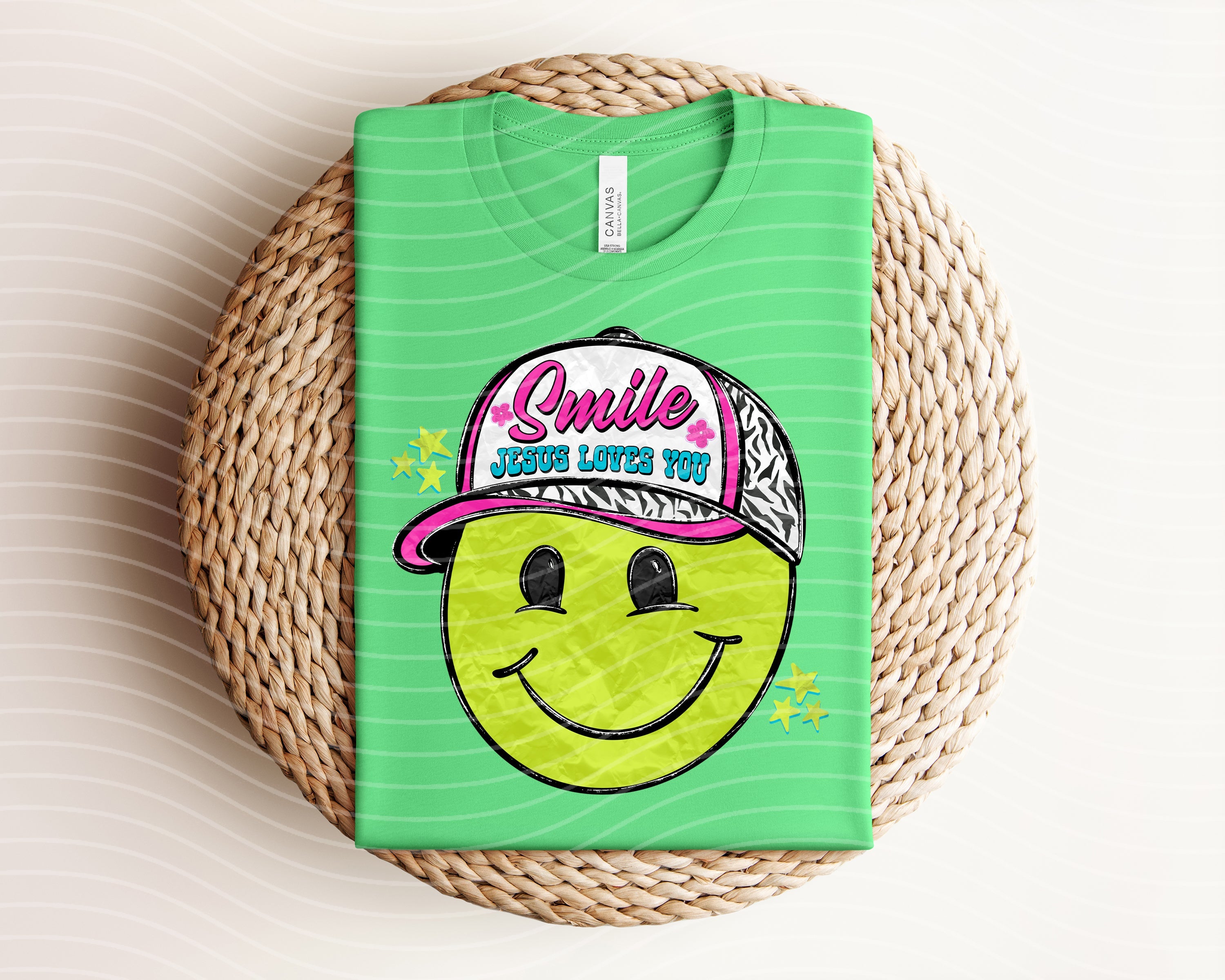 Black graphic tee by Anchored Grace Boutique featuring a smiley face and Jesus Loves You message on the front.