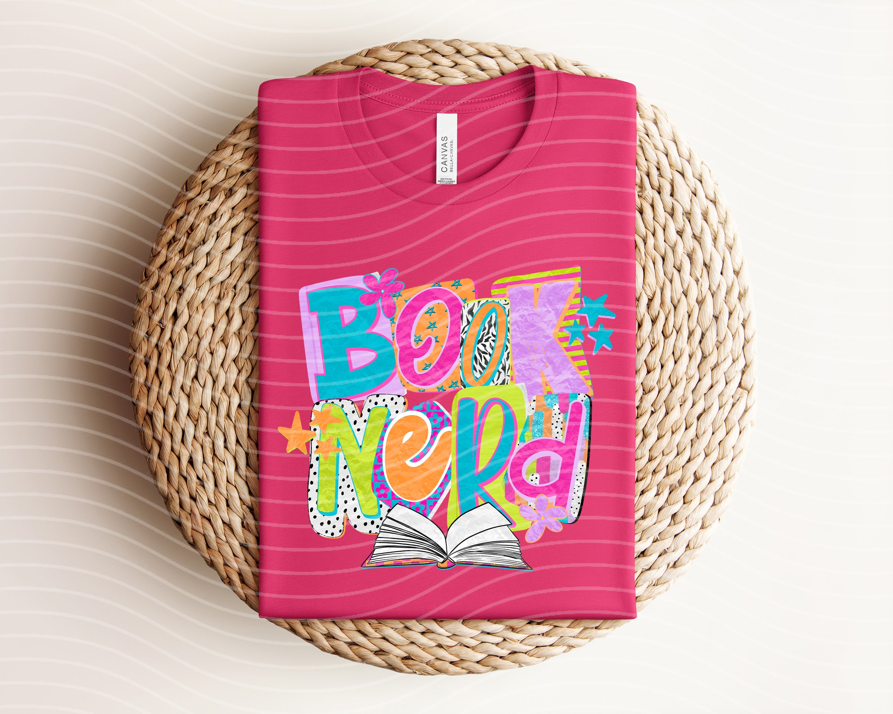 Black Book Nerd graphic tee from Anchored Grace Boutique featuring a book-themed design on soft cotton fabric.