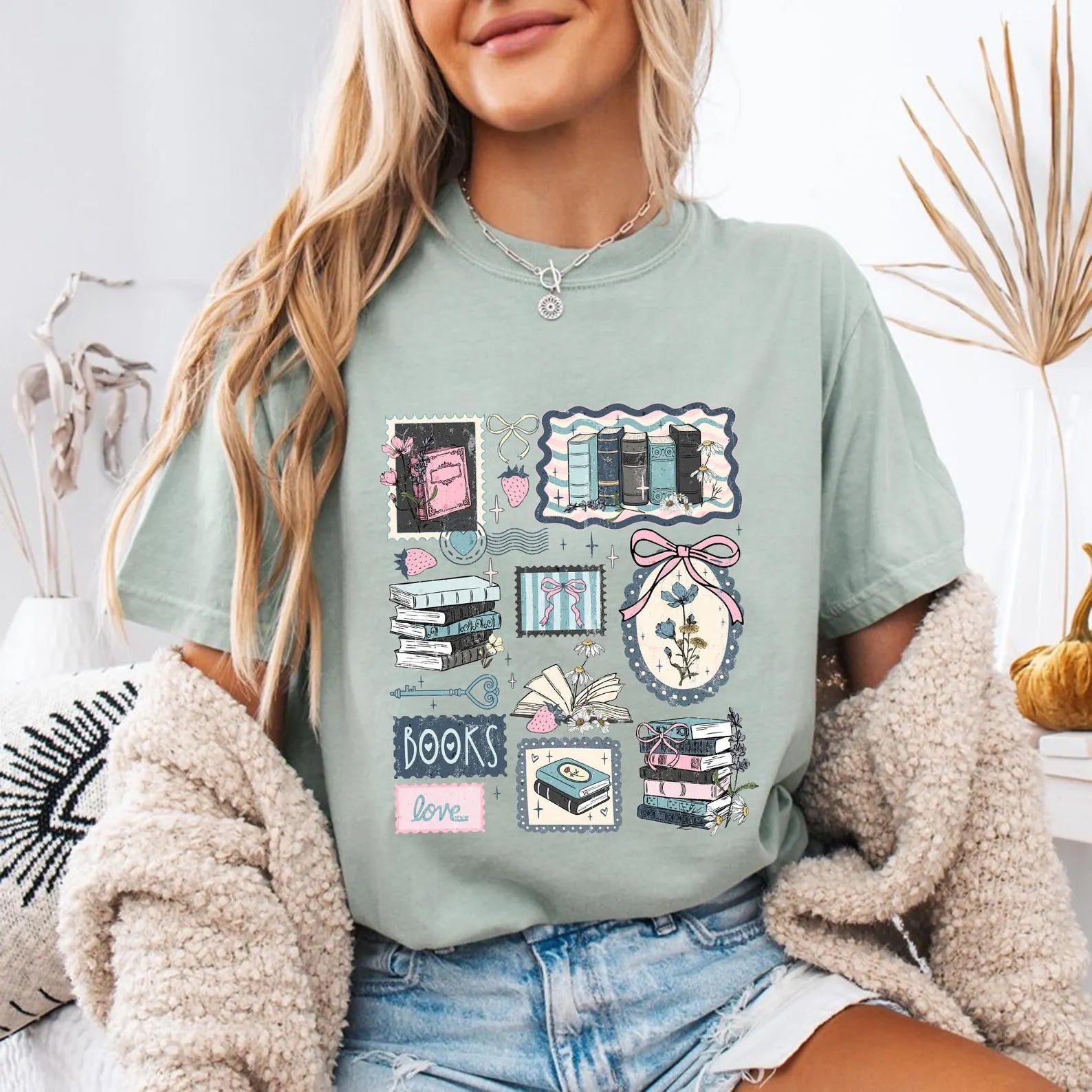 Love Books Stamps graphic tee featuring a printed design of love-themed stamps on a casual cotton t-shirt by Anchored Grace Boutique.