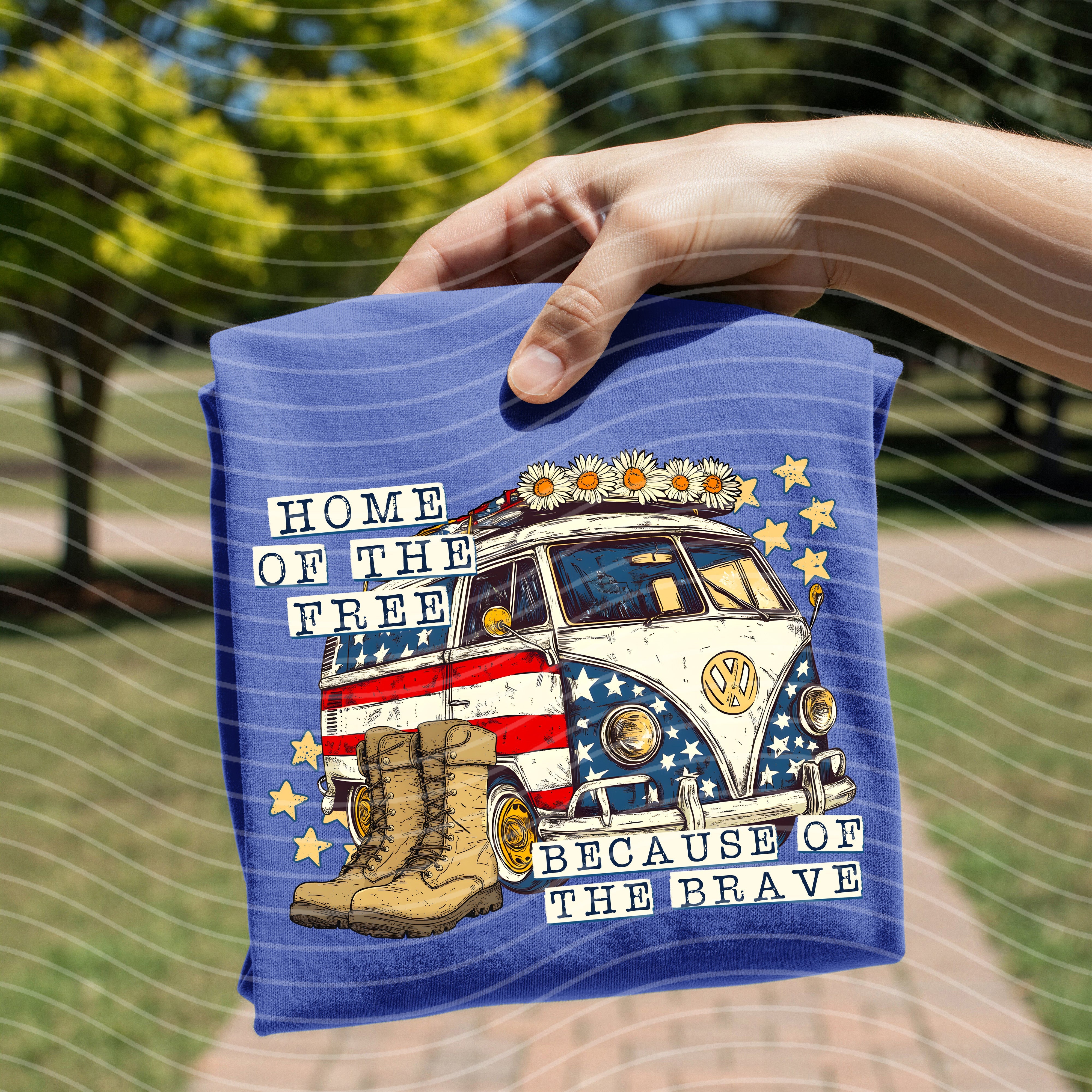 Gray graphic tee from Anchored Grace Boutique featuring "Home of the Free Because of the Brave" slogan and patriotic design.