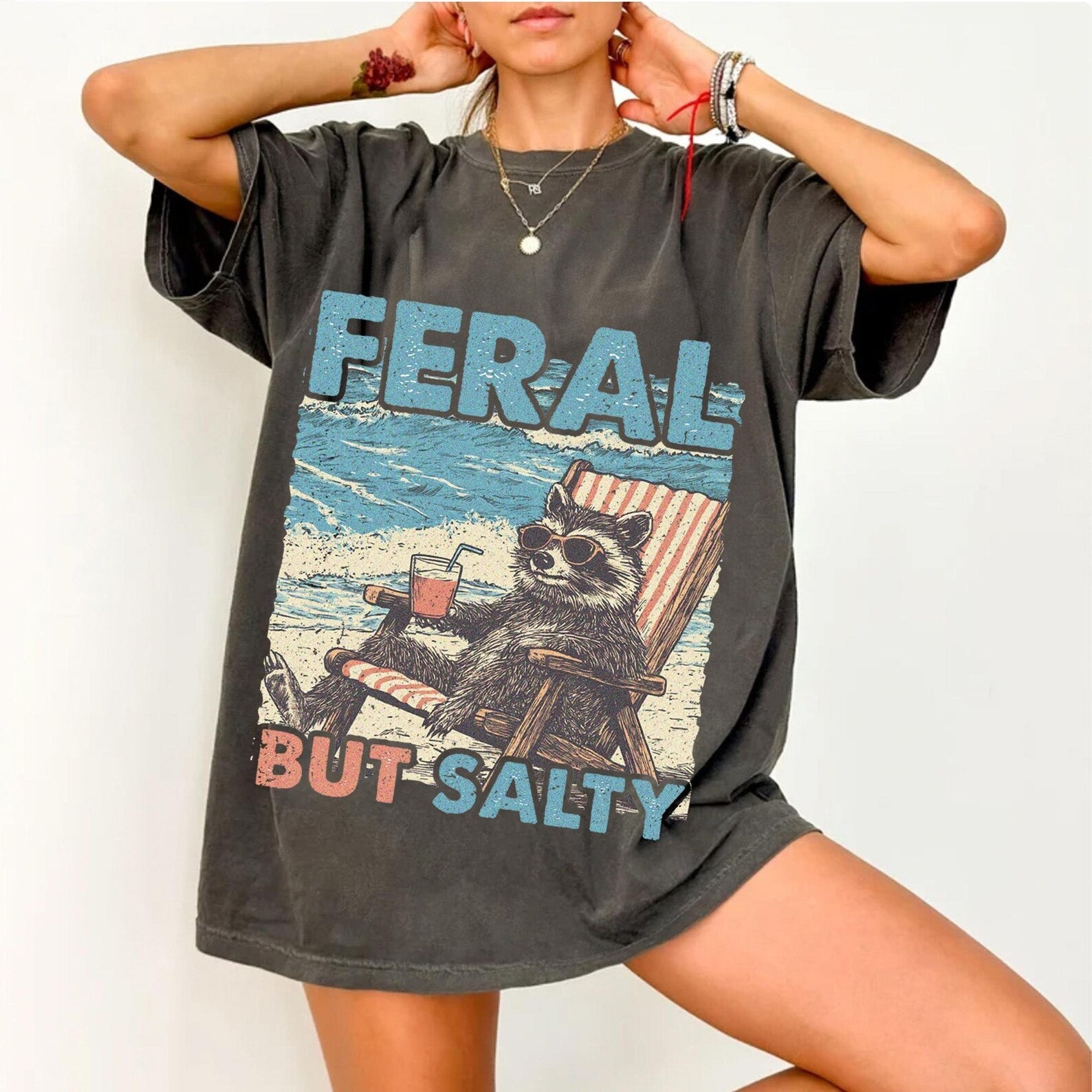 Feral But Salty graphic tee from Anchored Grace Boutique featuring a bold, colorful design on a casual cotton t-shirt.