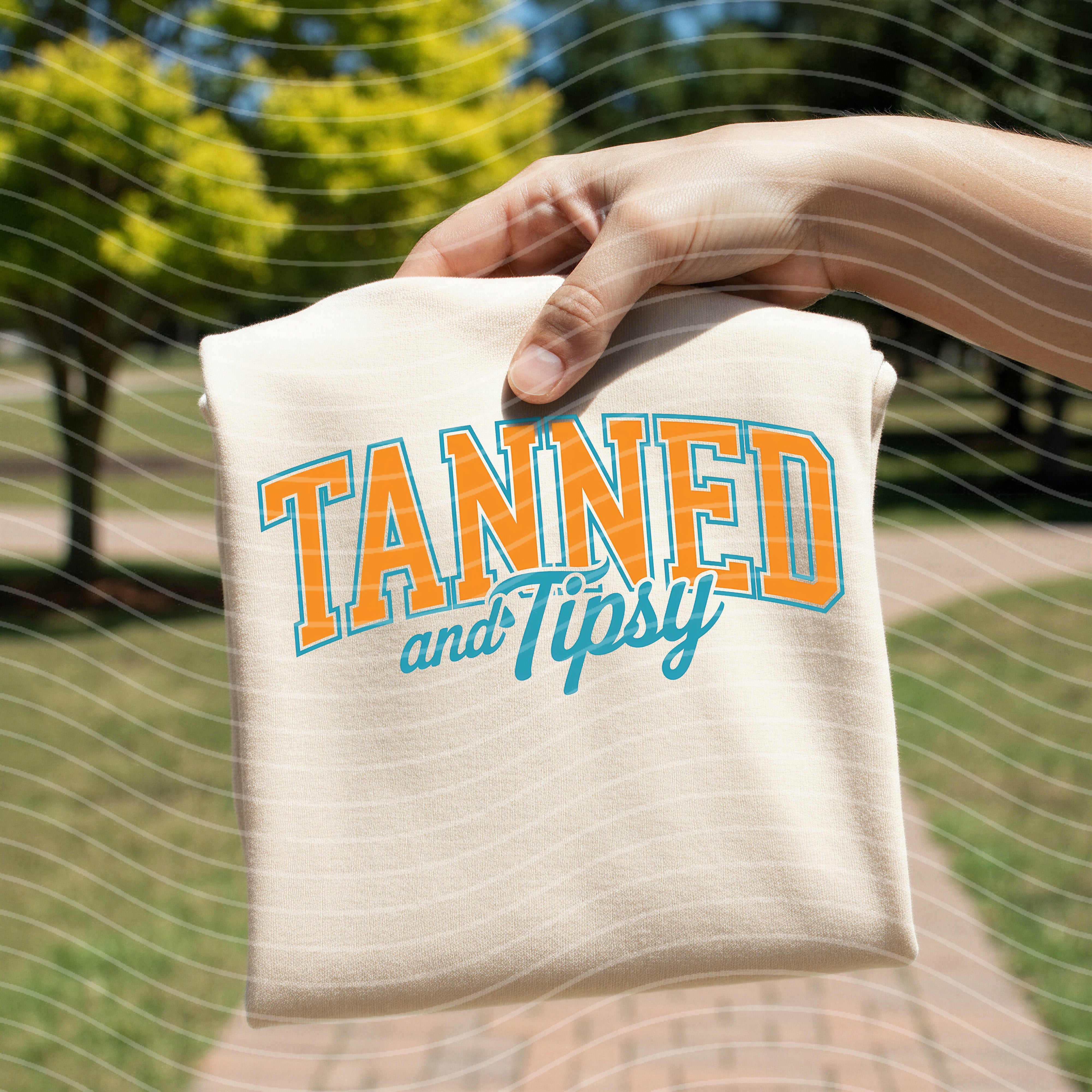Tanned and Tipsy graphic tee by Anchored Grace Boutique featuring a casual, stylish design on a comfortable cotton tee.