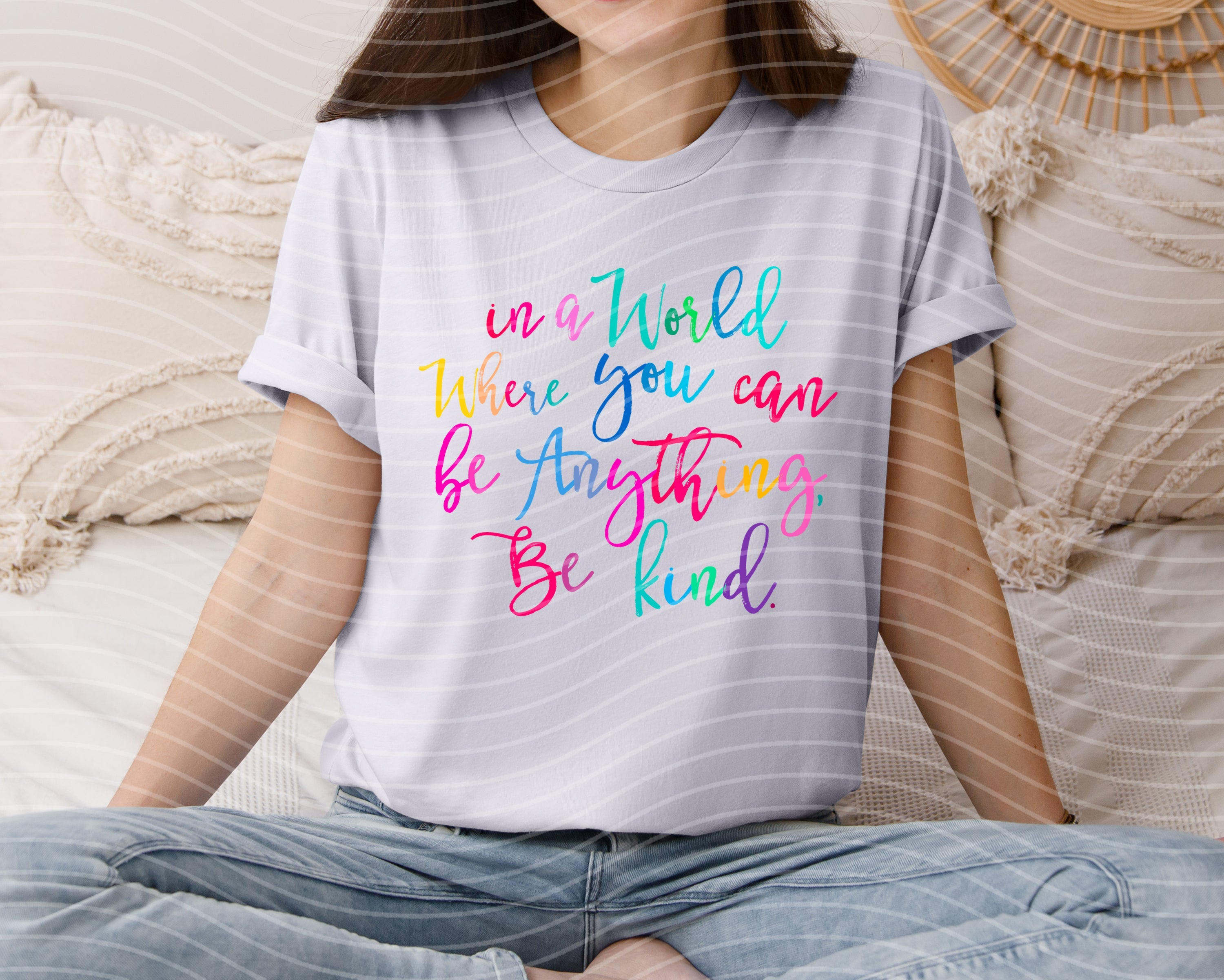 Pink graphic tee from Anchored Grace Boutique with "In a World Where You Can Be Anything Be Kind" slogan, casual and positive style.