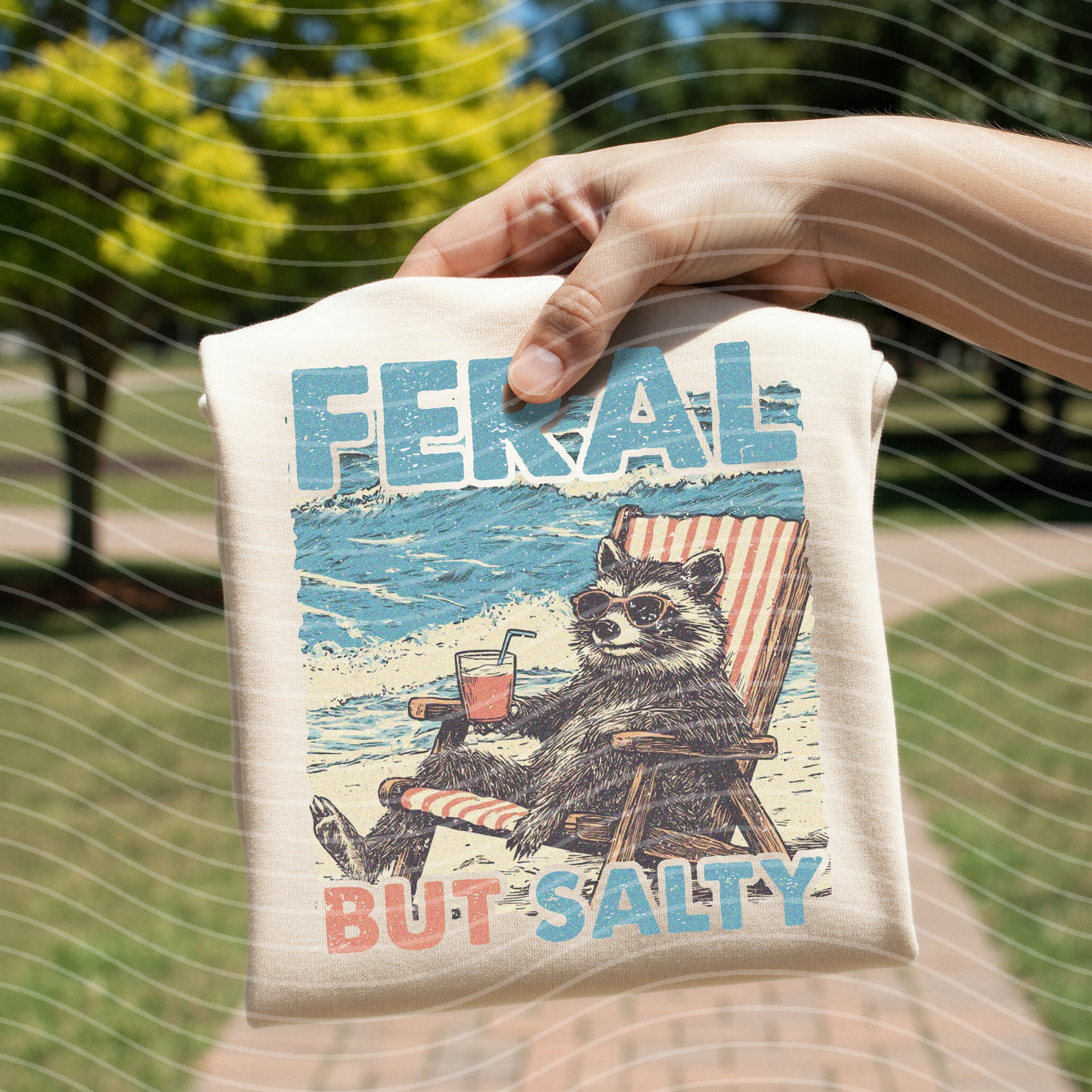 Feral But Salty graphic tee by Anchored Grace Boutique featuring bold lettering and casual fit on soft fabric.