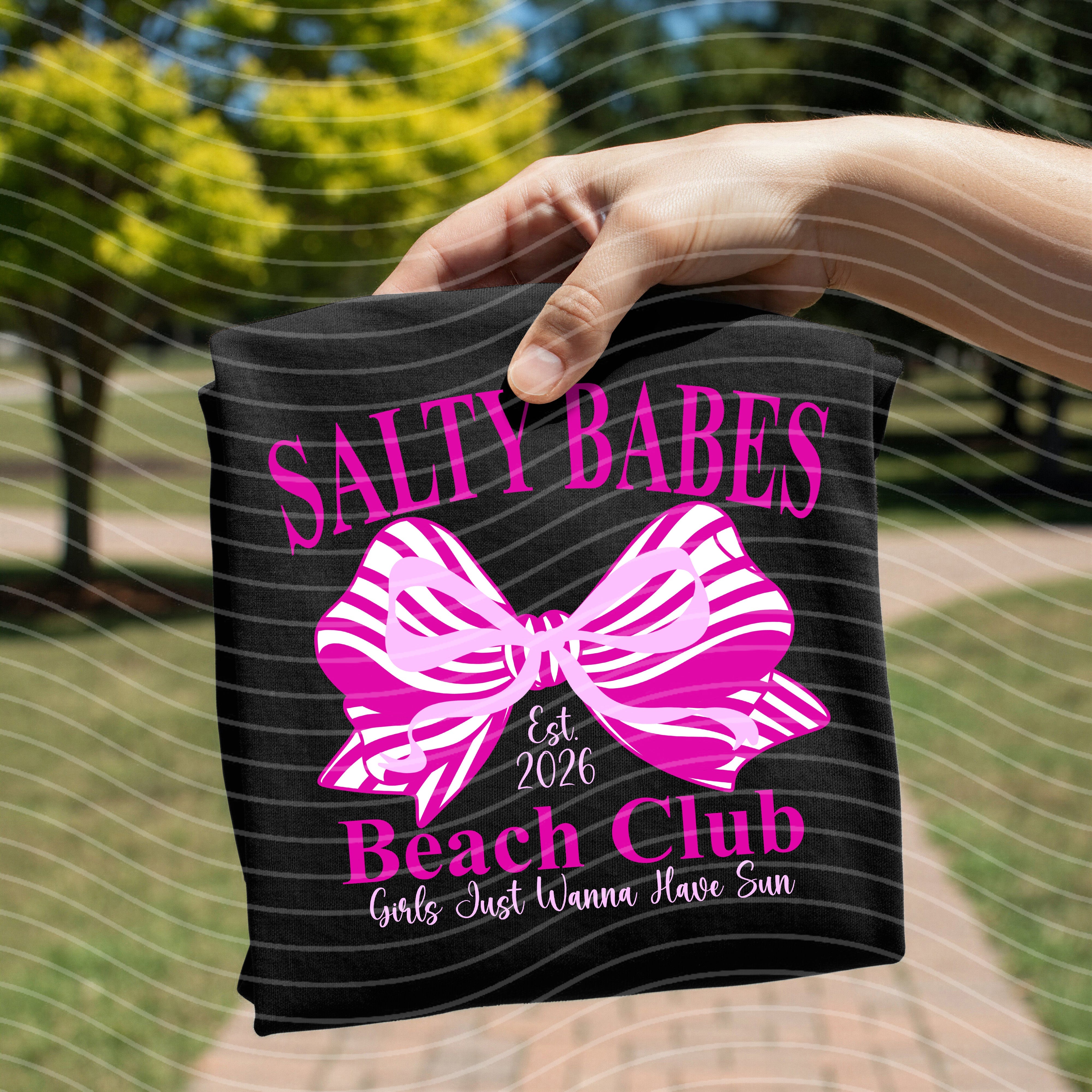Salty Babes Beach Club graphic tee by Anchored Grace Boutique, featuring a colorful beach scene on a casual cotton t-shirt.