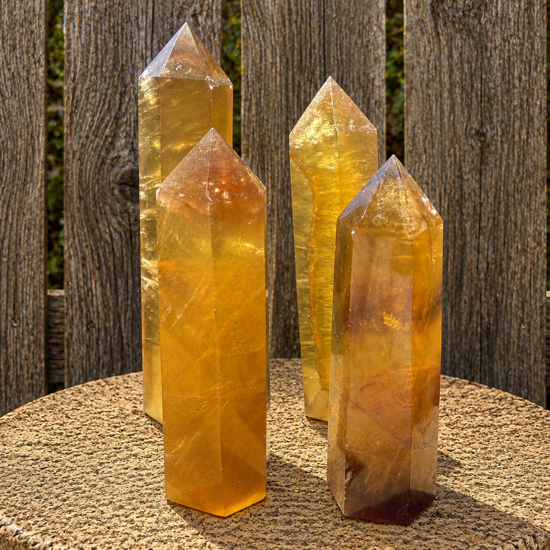 Yellow fluorite tower sculpture from natural stone, showcasing vibrant yellow hues and polished, geometric shape.