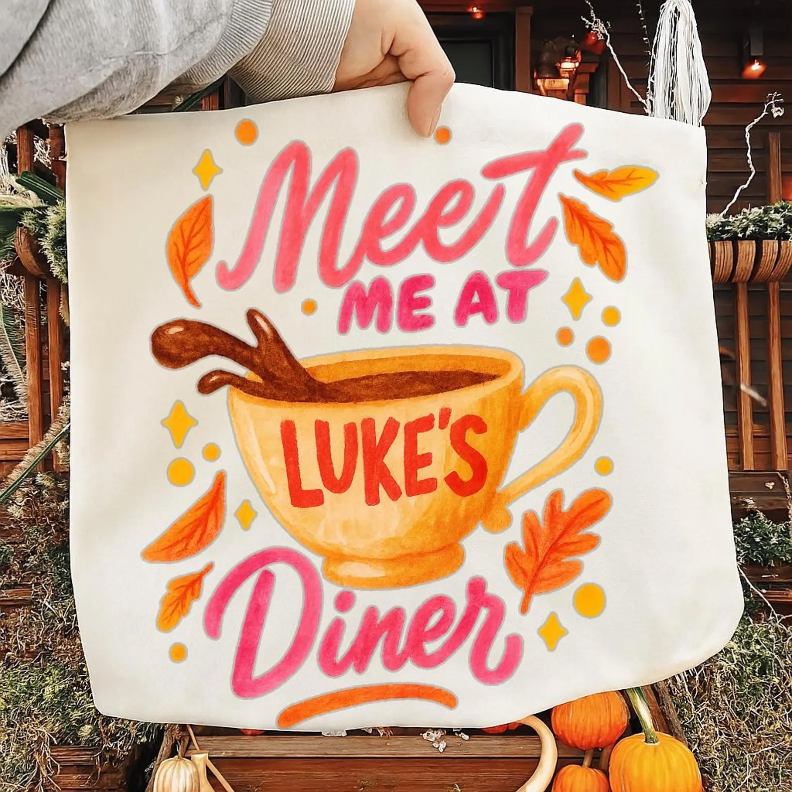 Gray graphic tee from Anchored Grace Boutique featuring "Meet Me at Luke's Diner" text and vintage-inspired design.
