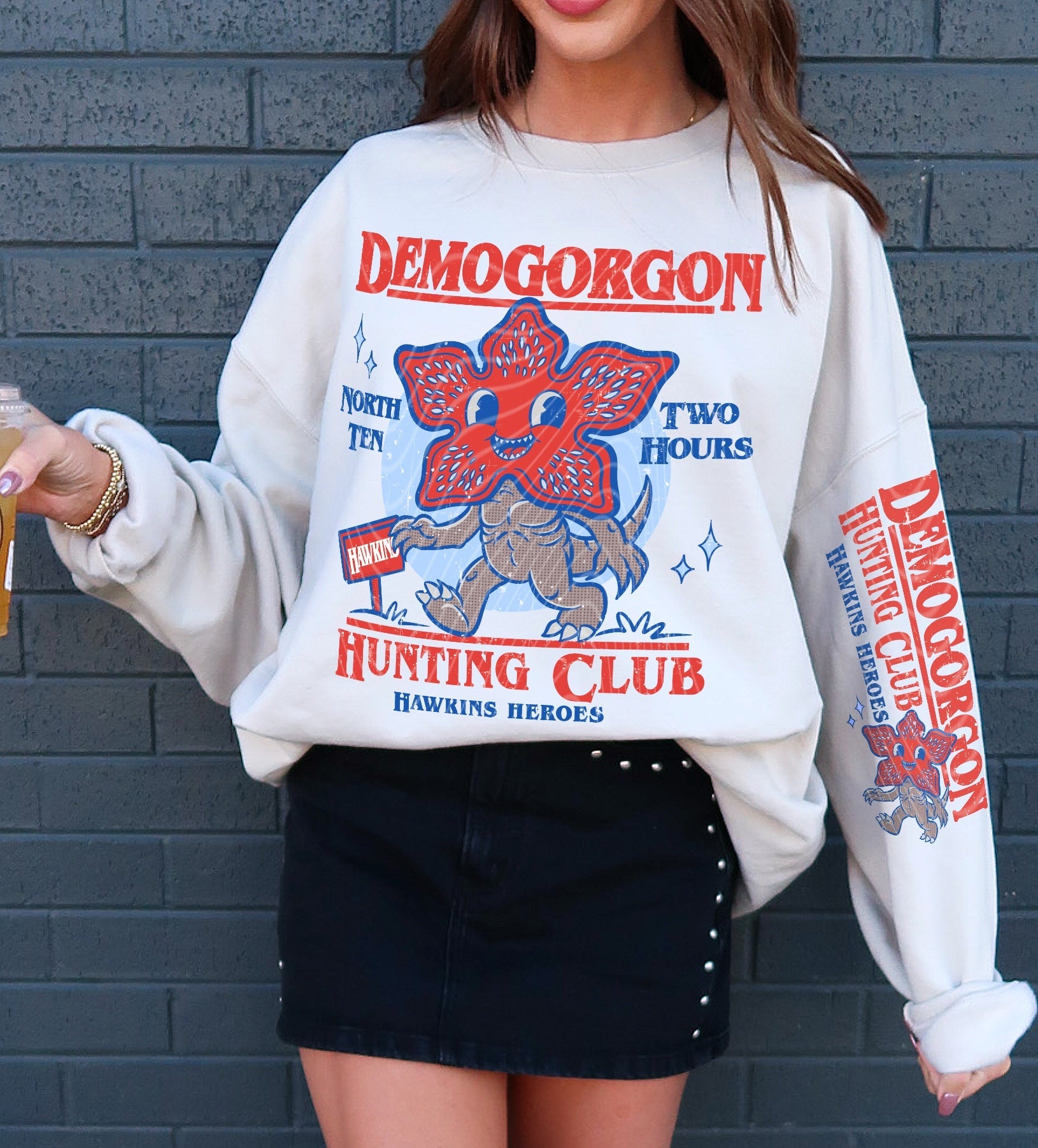 Demogorgon Hunting Club graphic tee from Anchored Grace Boutique featuring a bold, vintage-style monster illustration on black fabric.