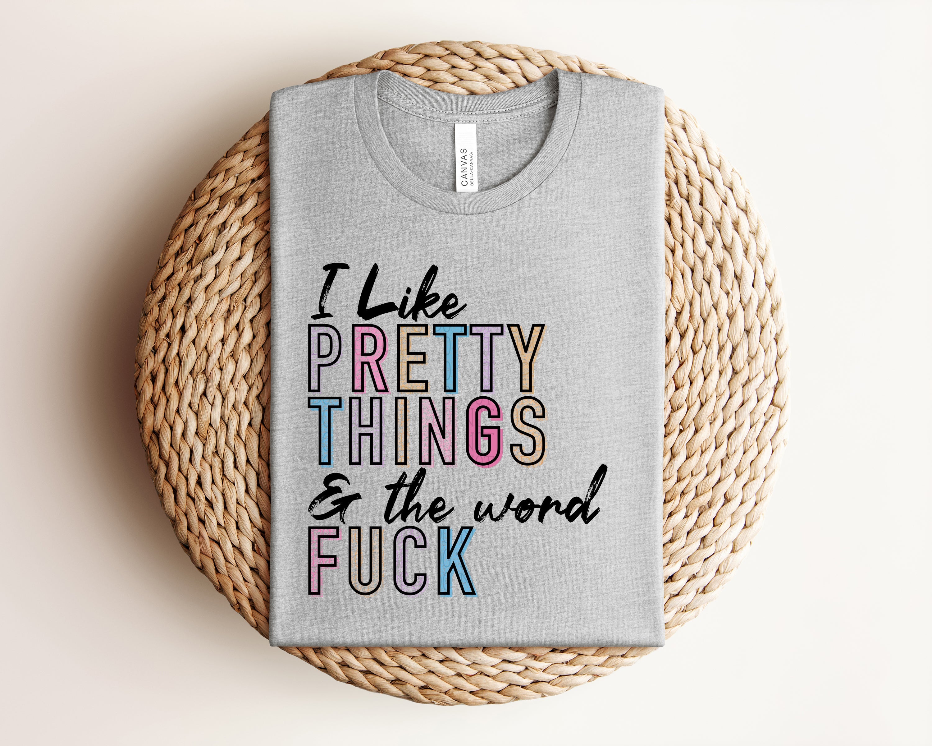 Pink graphic tee by Anchored Grace Boutique with "I Like Pretty Things" slogan, casual style, and soft fabric.