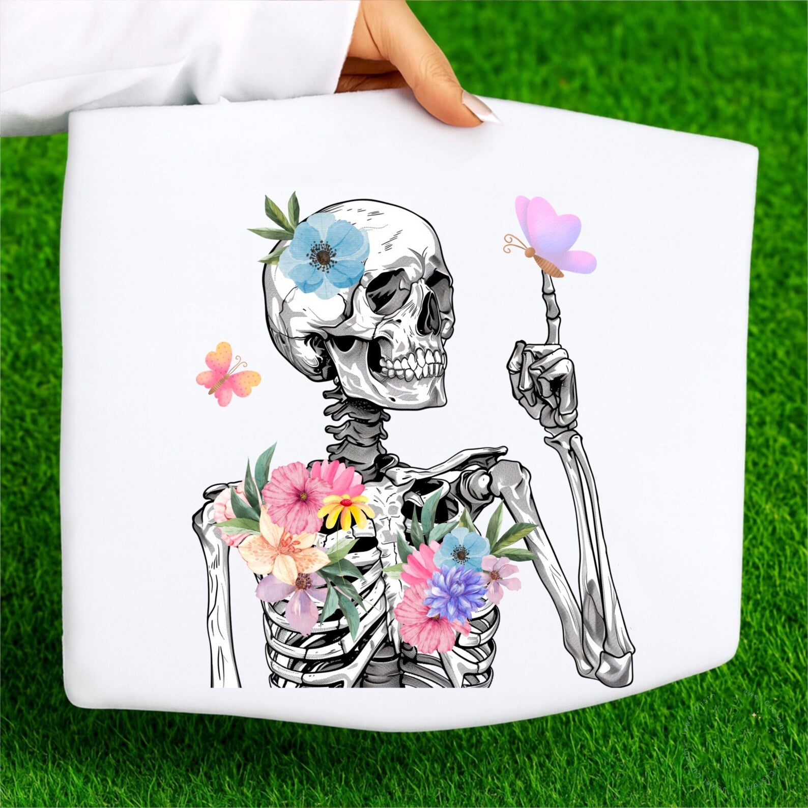 Spring Skelly graphic tee by Anchored Grace Boutique featuring a colorful skeleton design on a casual cotton t-shirt.