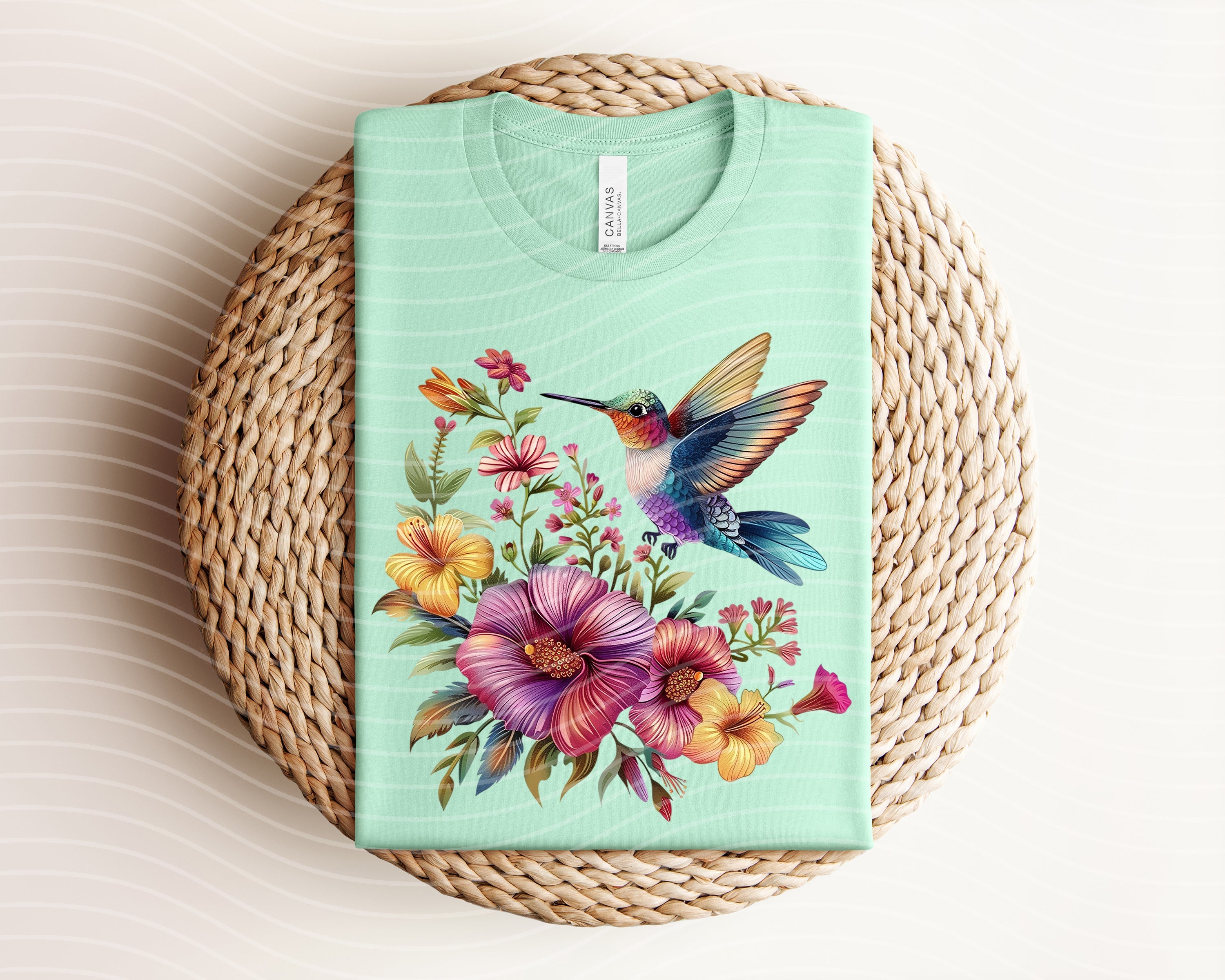 Hummingbird graphic tee from Anchored Grace Boutique featuring a colorful hummingbird design on soft cotton fabric.