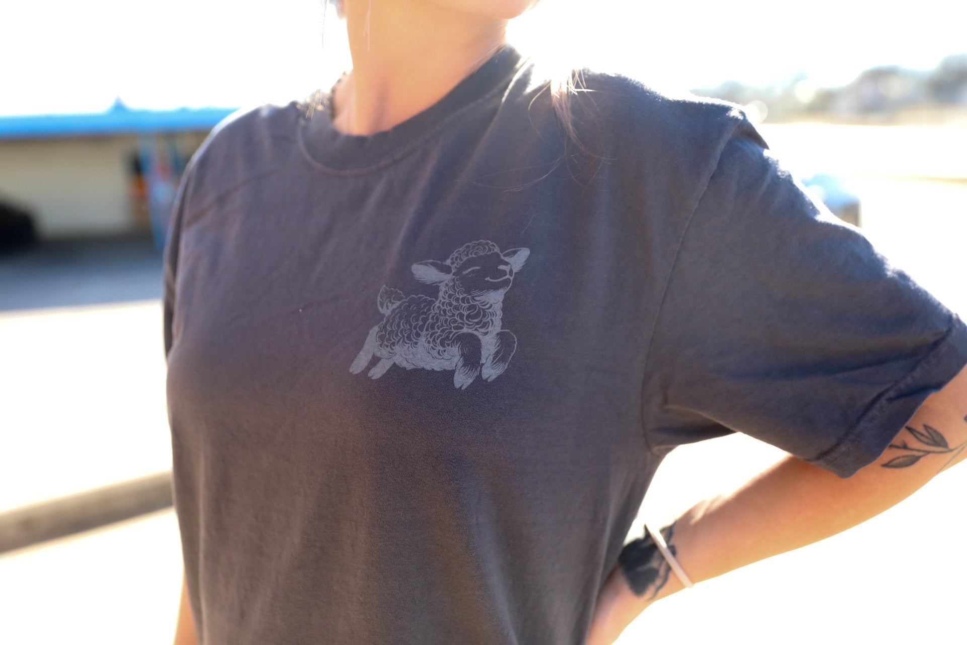 Black sheep graphic tee or sweatshirt from Shop Karma Tees featuring a stylish sheep design on black fabric.