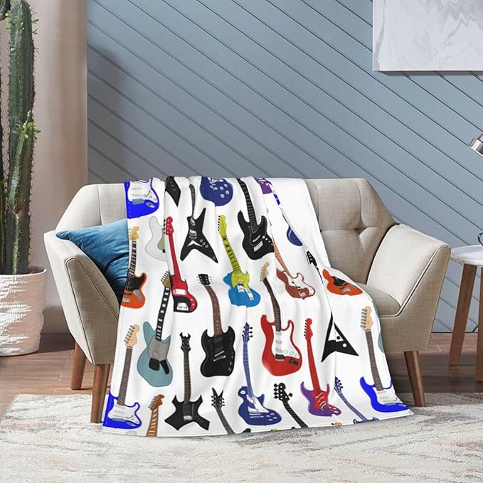 CozyNest Decor electric guitar pattern fleece throw blanket, soft music-themed blanket for kids and adults, 60x50 inches.