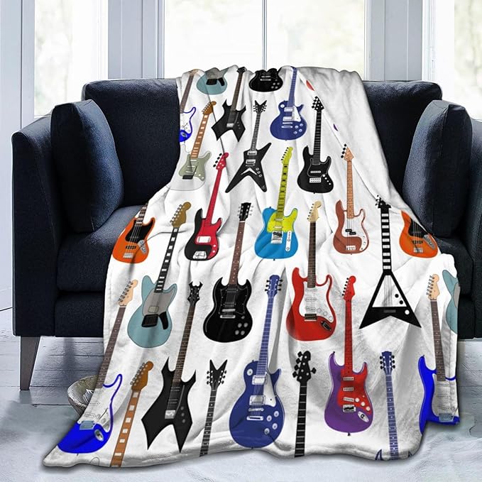 CozyNest Decor electric guitar pattern fleece throw blanket on sofa, 60x50 inches, ideal for kids, teens, and music-themed decor.