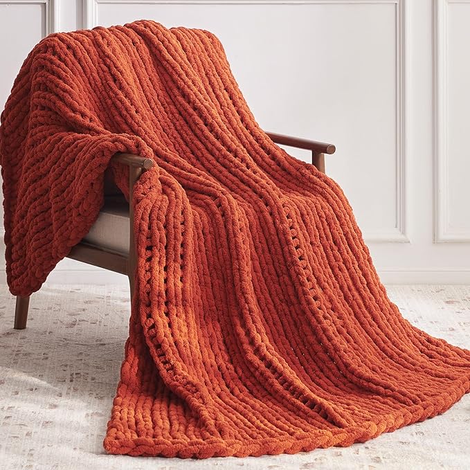 CozyNest Decor chunky knit throw blanket in orange, handmade crocheted chenille yarn, perfect for bed or couch decor.