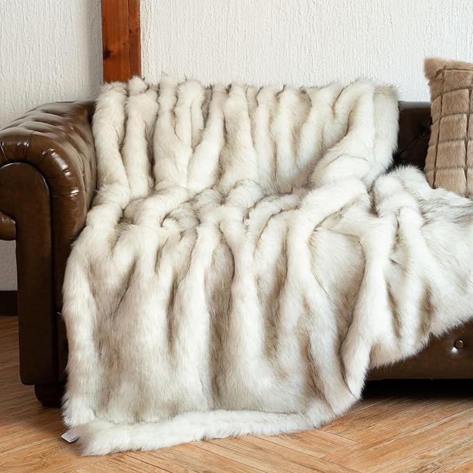 Luxury ivory white faux fur throw blanket by CozyNest Decor, super soft, plush, and reversible to velvet, perfect for bed or couch.