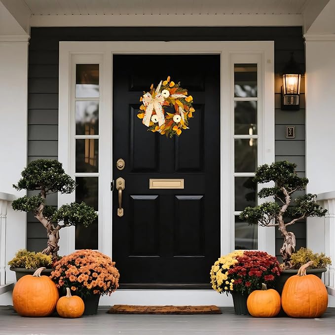 Rustic fall wreath by CozyNest Decor featuring white pumpkins, golden eucalyptus, wheat, and a bow for front door decor.