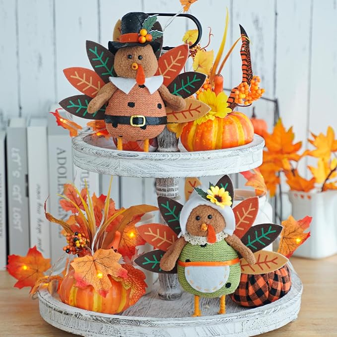 Two plush stuffed turkey figurines with dangling legs, CozyNest Decor Thanksgiving harvest tabletop decorations for fall and autumn decor.