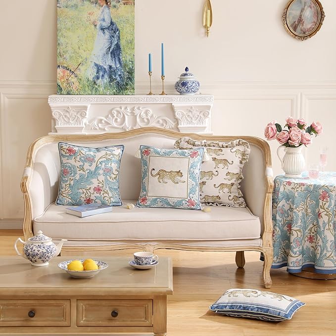 Set of four CozyNest Decor throw pillow covers featuring vintage French linen with cheetah pattern and gold pendant accents.