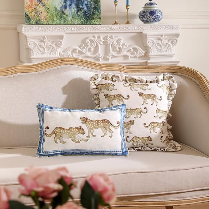 Set of four CozyNest Decor throw pillow covers with vintage French linen, cheetah pattern, and luxurious pendant accents.