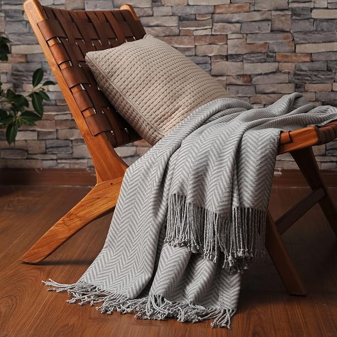 CozyNest Decor Cuddle Dreams silk throw blanket in herringbone gray with hand-knotted fringe, soft and breathable for cozy comfort.