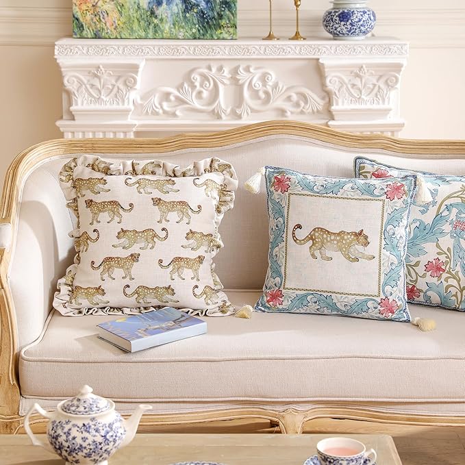 Set of four CozyNest Decor designer throw pillow covers with vintage French linen, cheetah pattern, and luxury pendant accents.