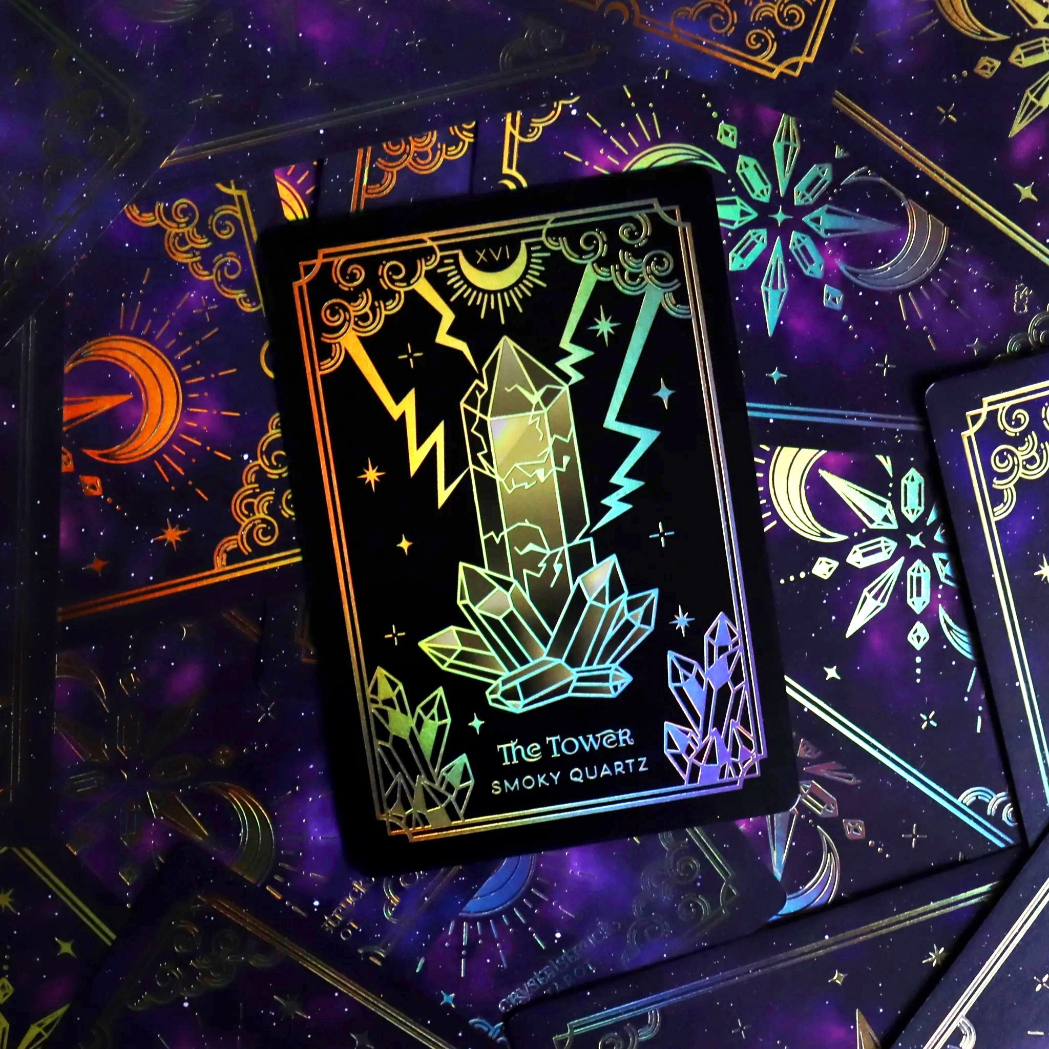 Mini Gold Crystalstruck Tarot card deck by Moonstruck Crystals featuring intricate gold-embossed card designs on a dark background.