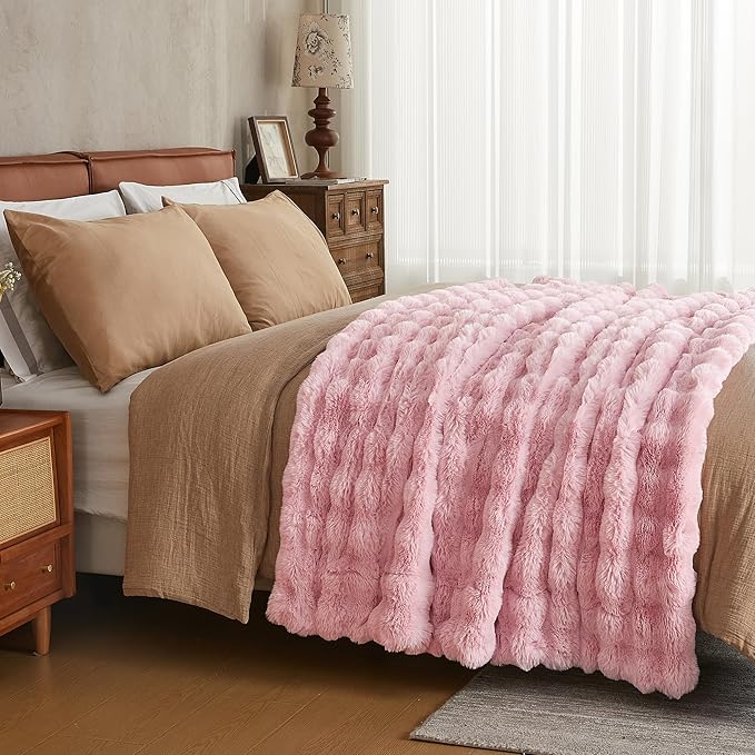 Pink fuzzy faux fur bed blanket by CozyNest Decor, thick, plush, cozy throw in king size for warmth and comfort.