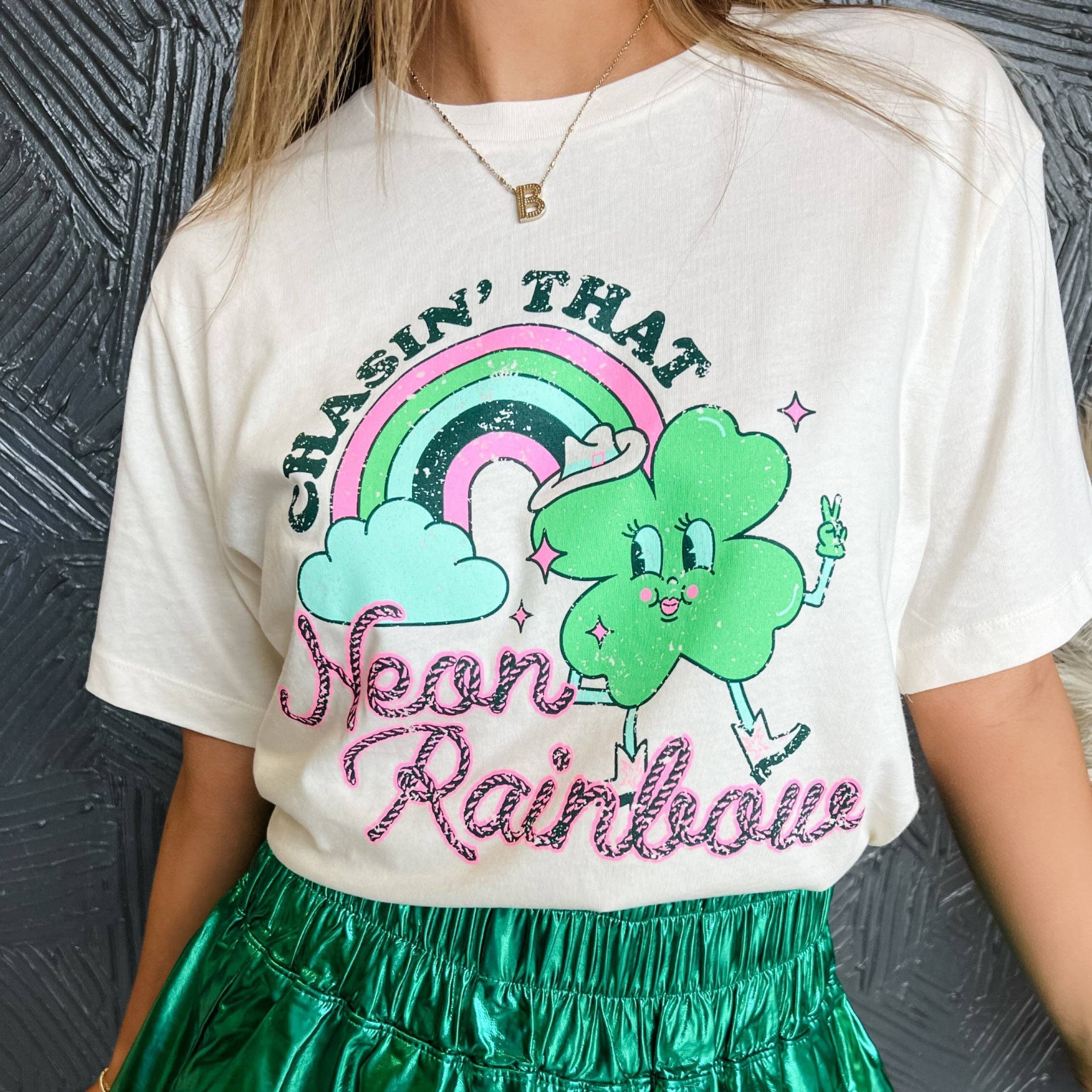 Bright neon rainbow shirt from The Bullish Store, casual apparel in sizes SM to 2XL, featuring colorful rainbow design.