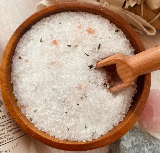 Eucalyptus spa herbal bath salts in transparent tubes with eucalyptus leaves, used for relaxing body care and wellness.
